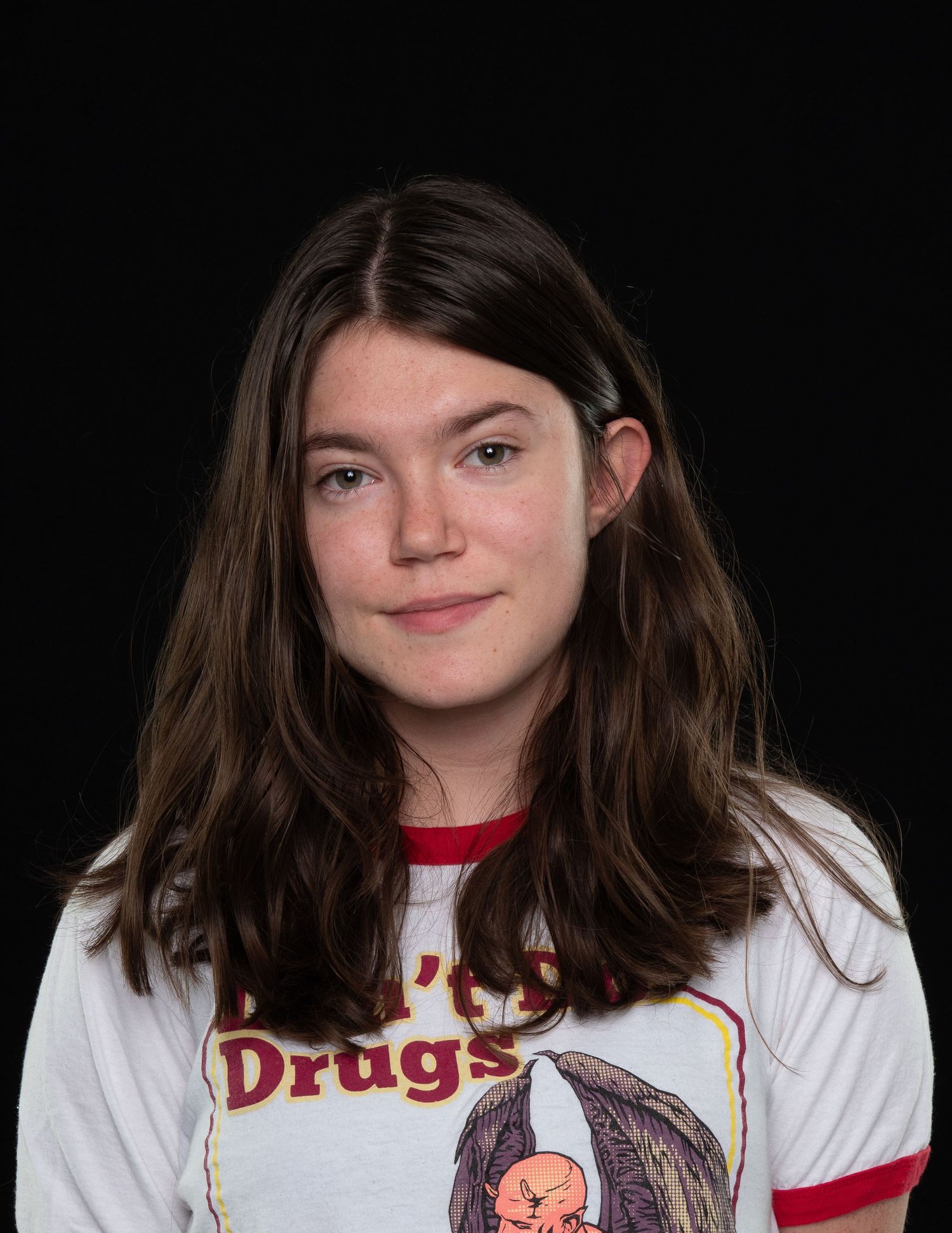 woman headshot black background long hair white shirt