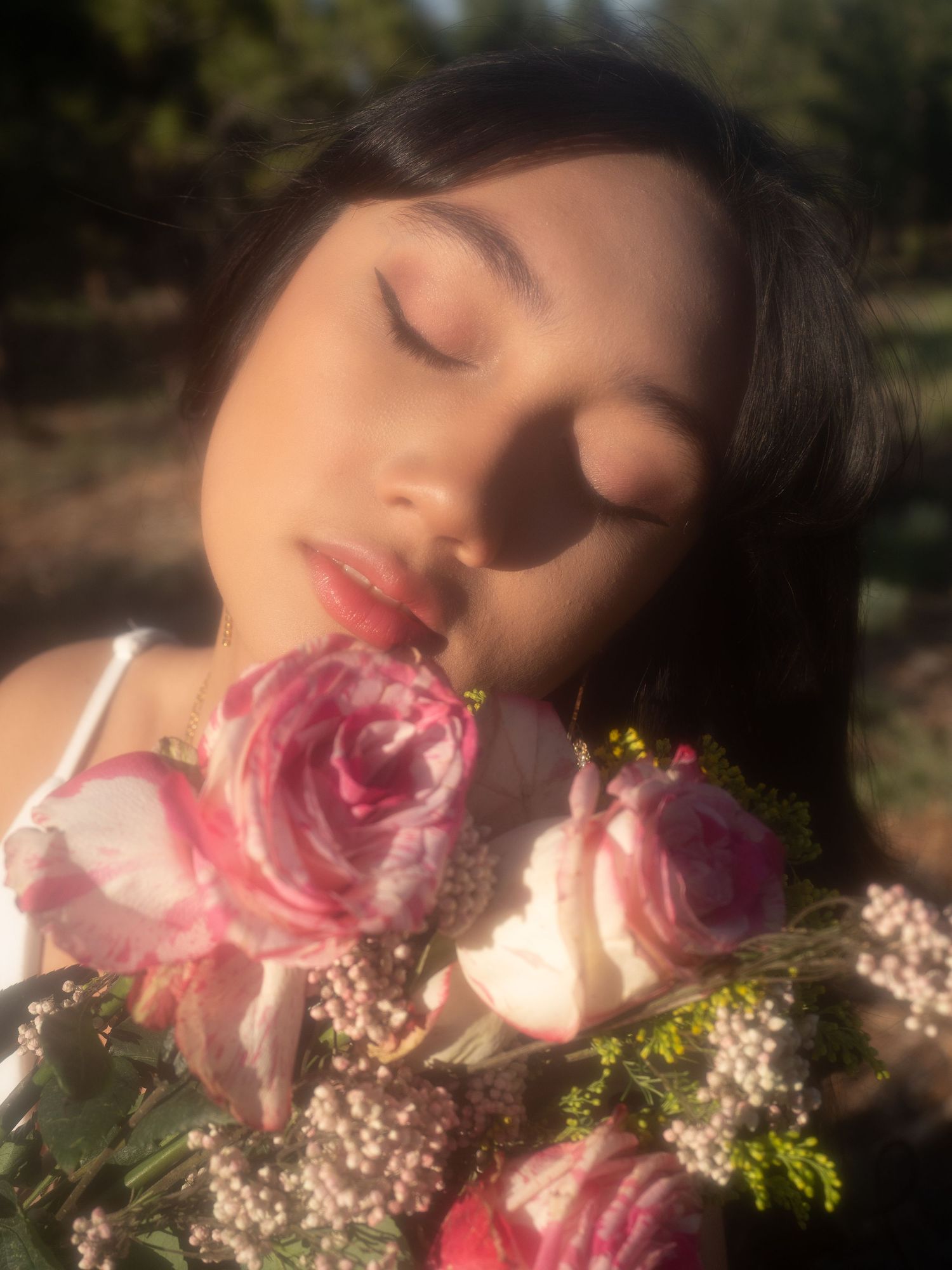 woman portrait glowy skin head in bouquet of flowers