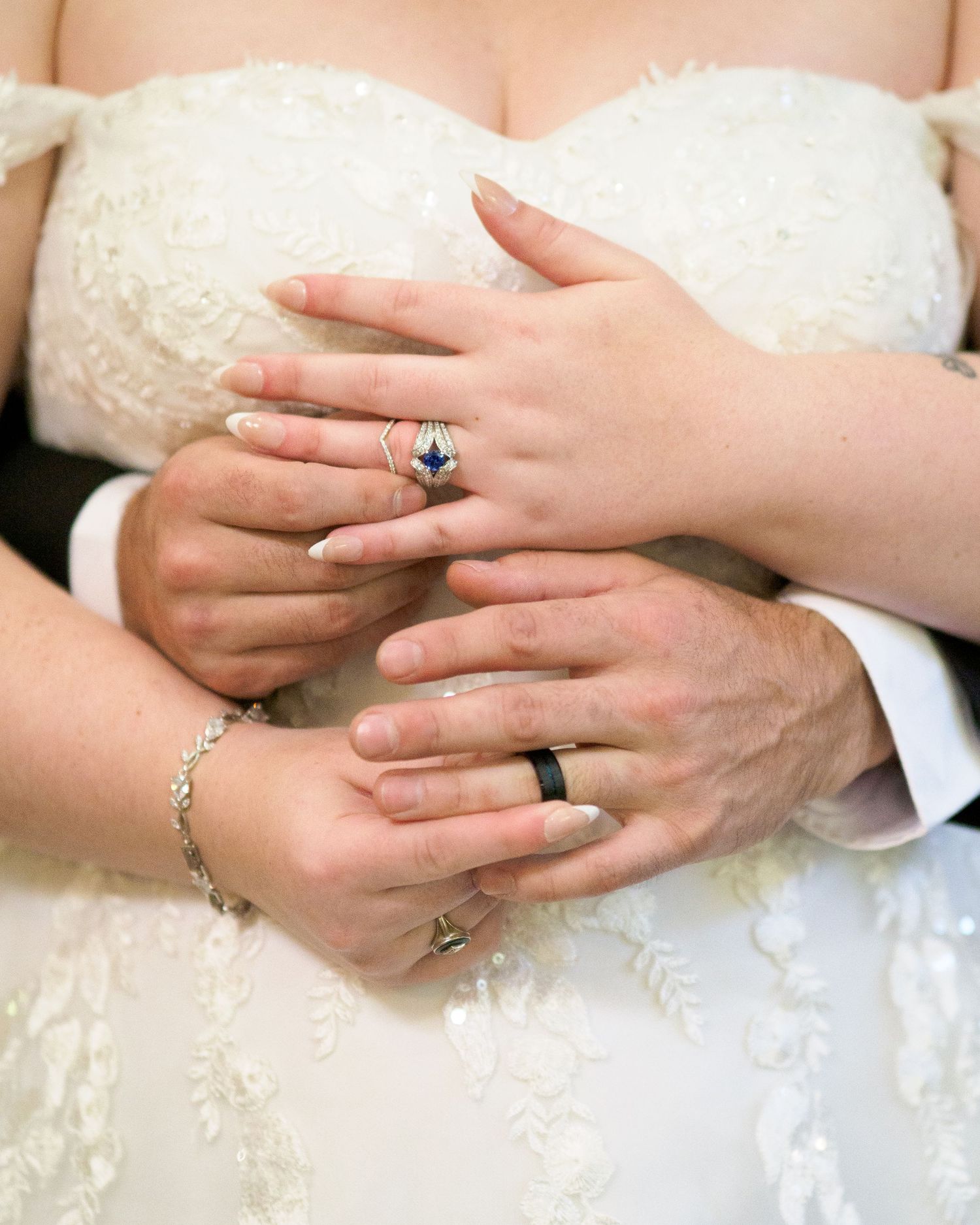 wedding photo portrait bride dress hands in front putting on rings