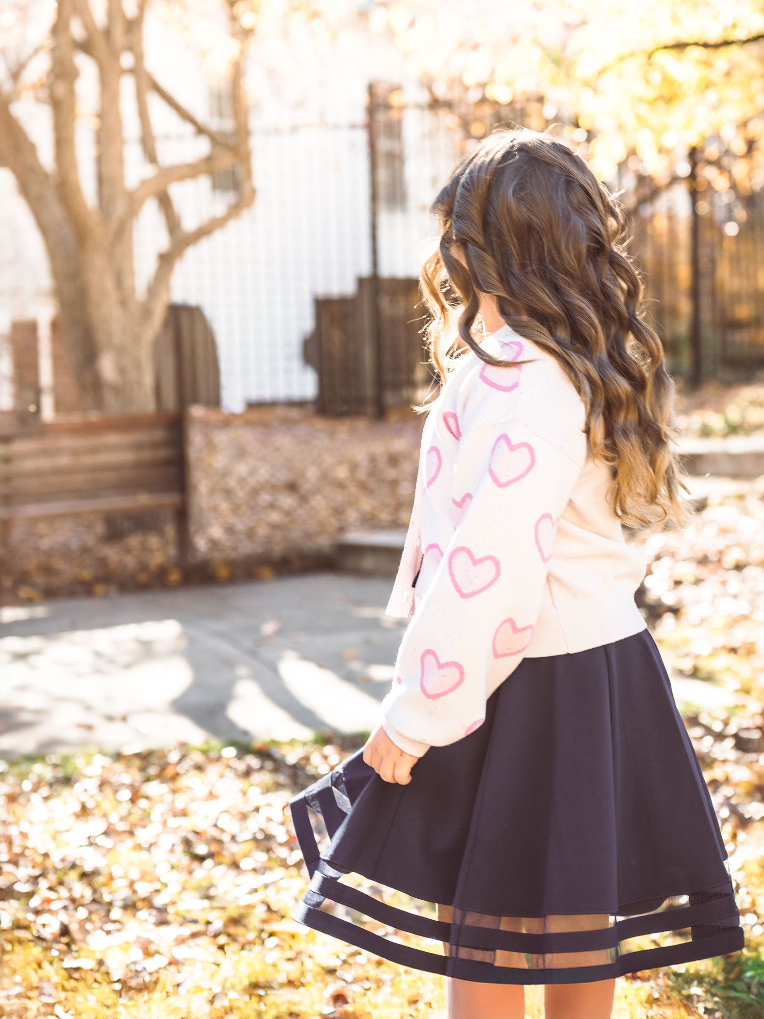 child in dress in park portrait twirling sunny warm