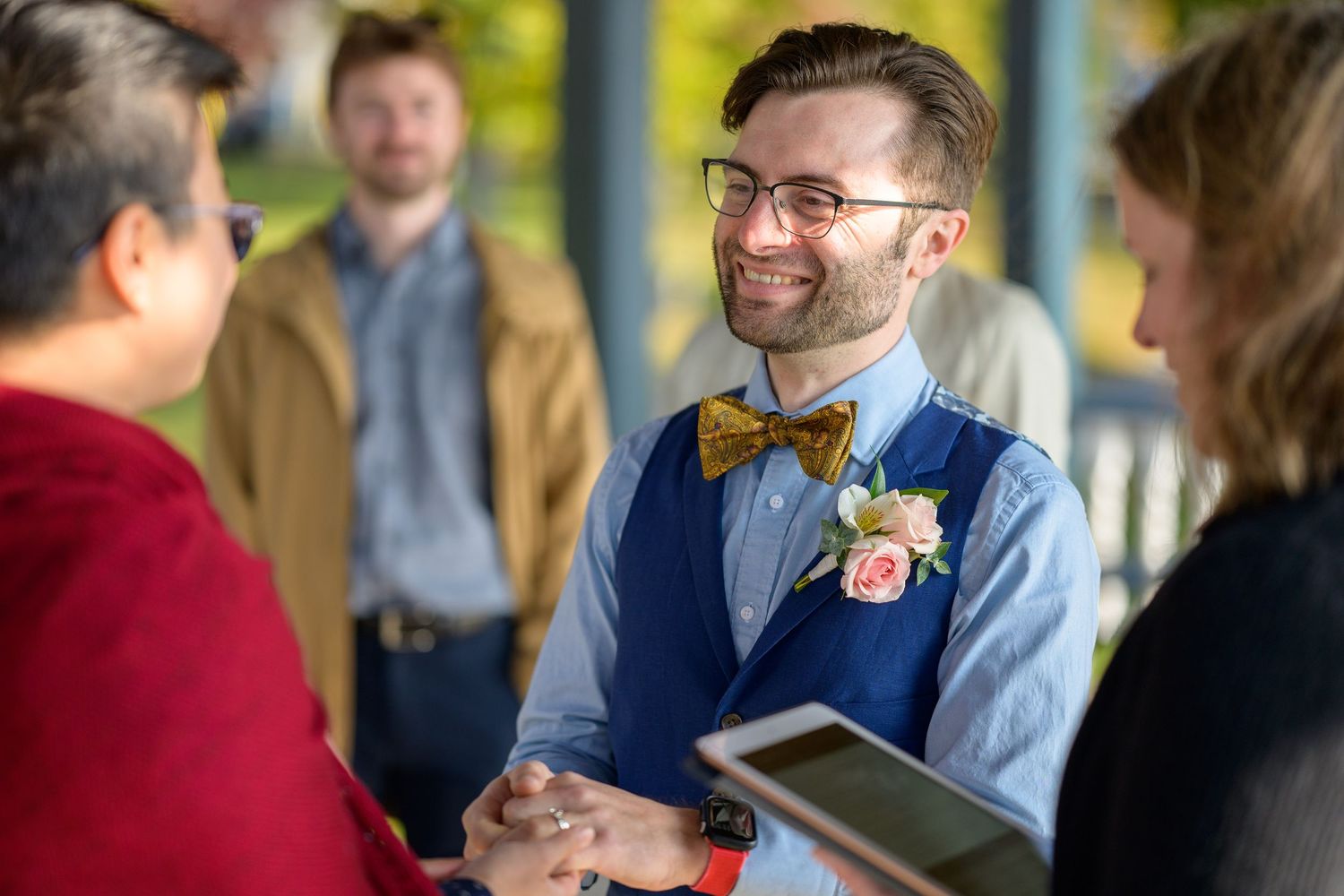 A candid wedding photo showing guests laughing and interacting during a joyful celebration.