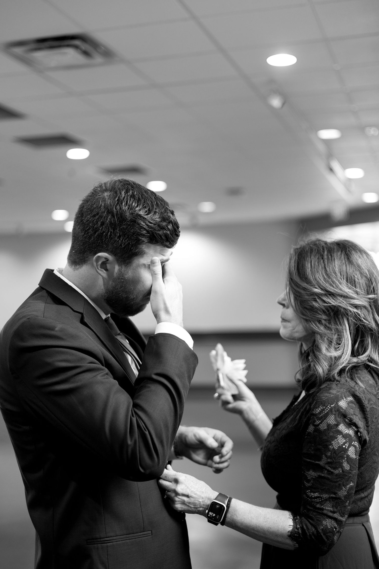 Candid black and white photos of two people interacting in an indoor setting.