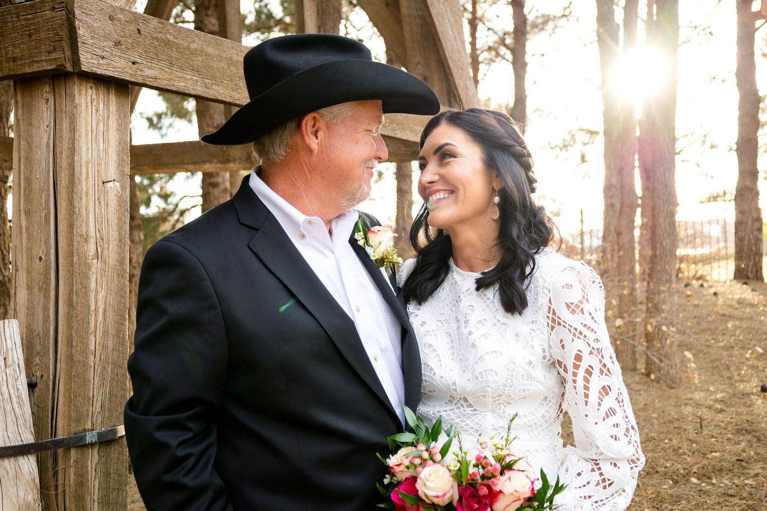 Romantic wedding portraits captured in a rustic wooden gazebo setting.