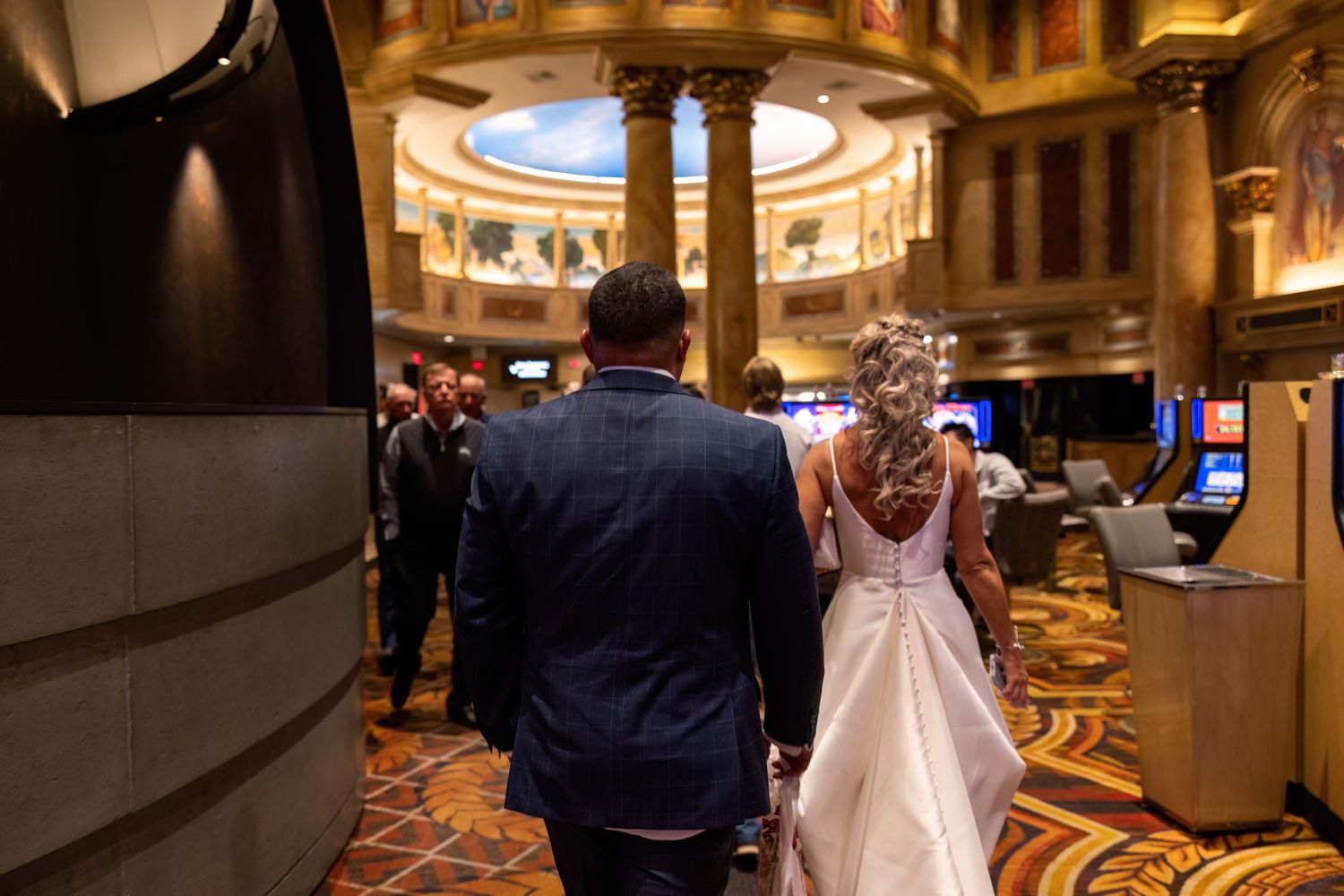 Elegant wedding venue with ornate gold decor and lighting.
