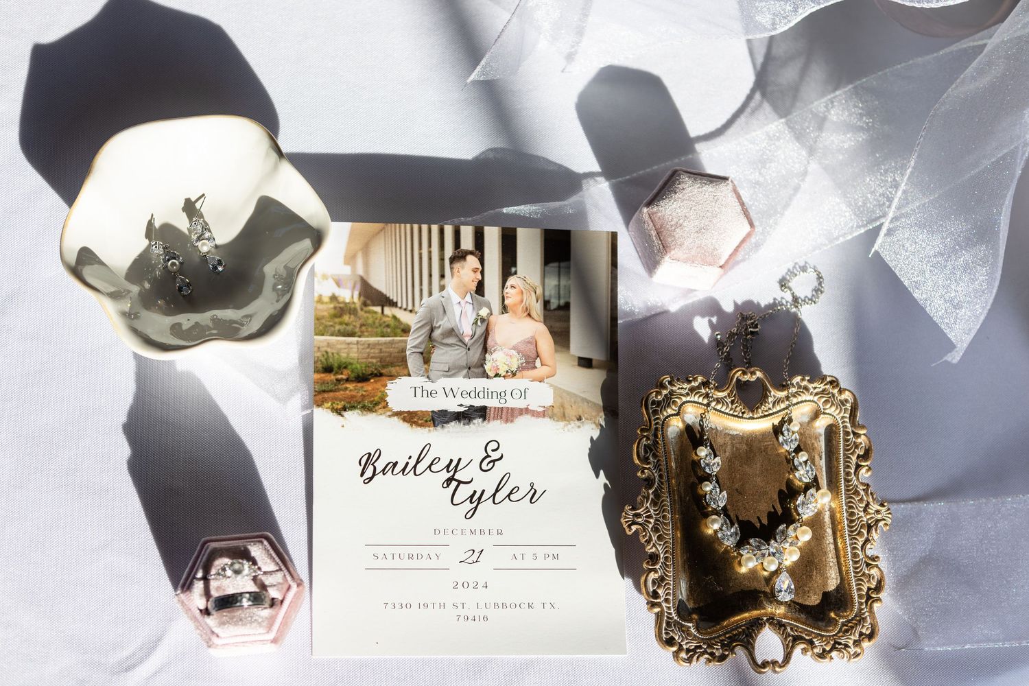 Wedding invitation displayed with decorative elements and vintage frames on a light background.