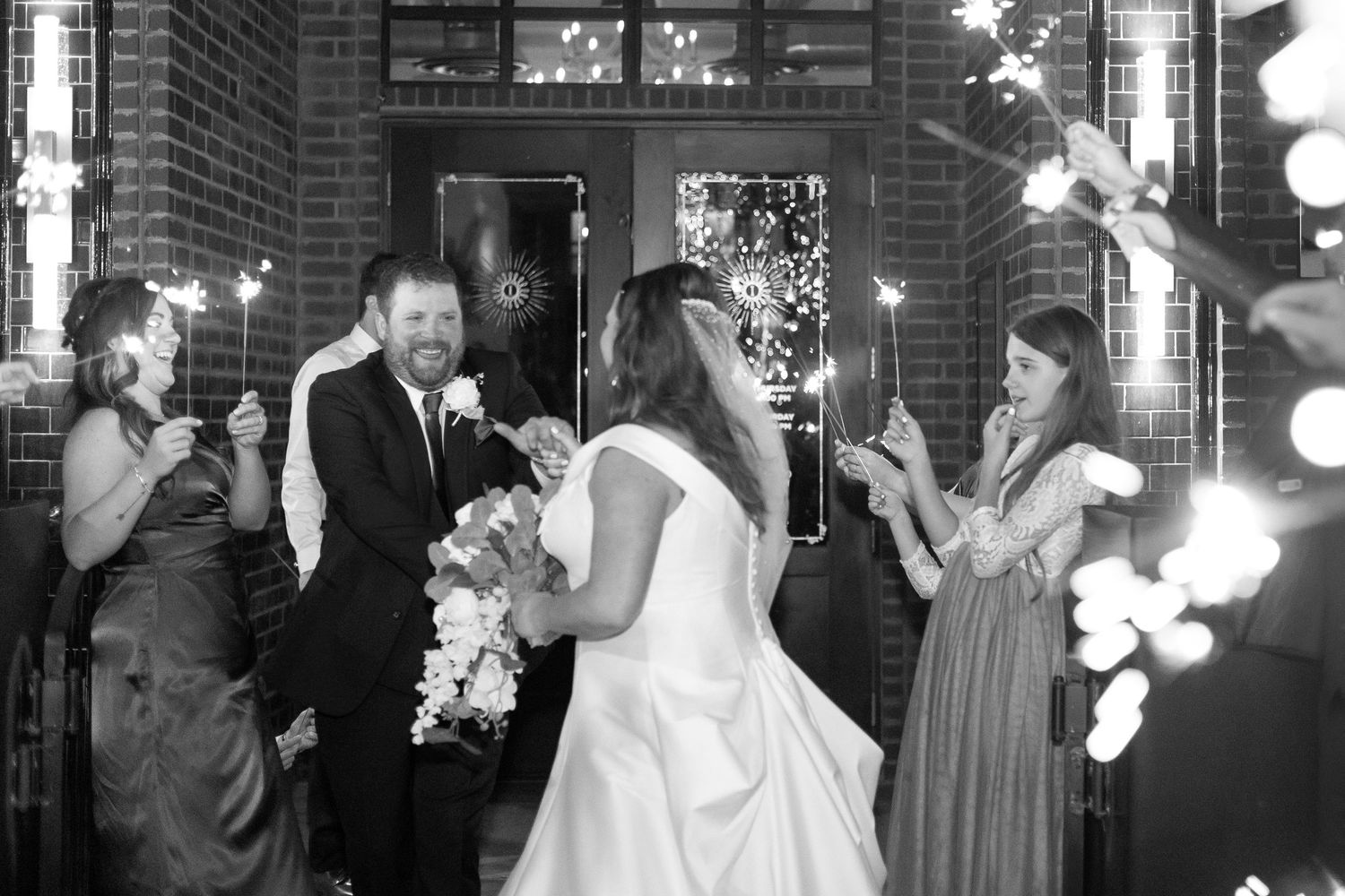 Evening wedding celebration with sparklers creating a magical outdoor atmosphere.