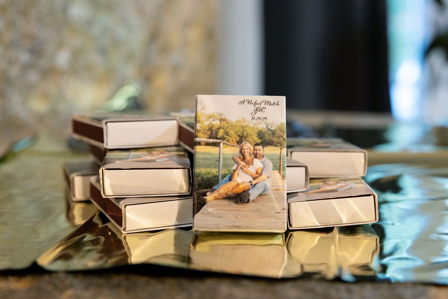 Stack of vintage books arranged in a row on a reflective surface.