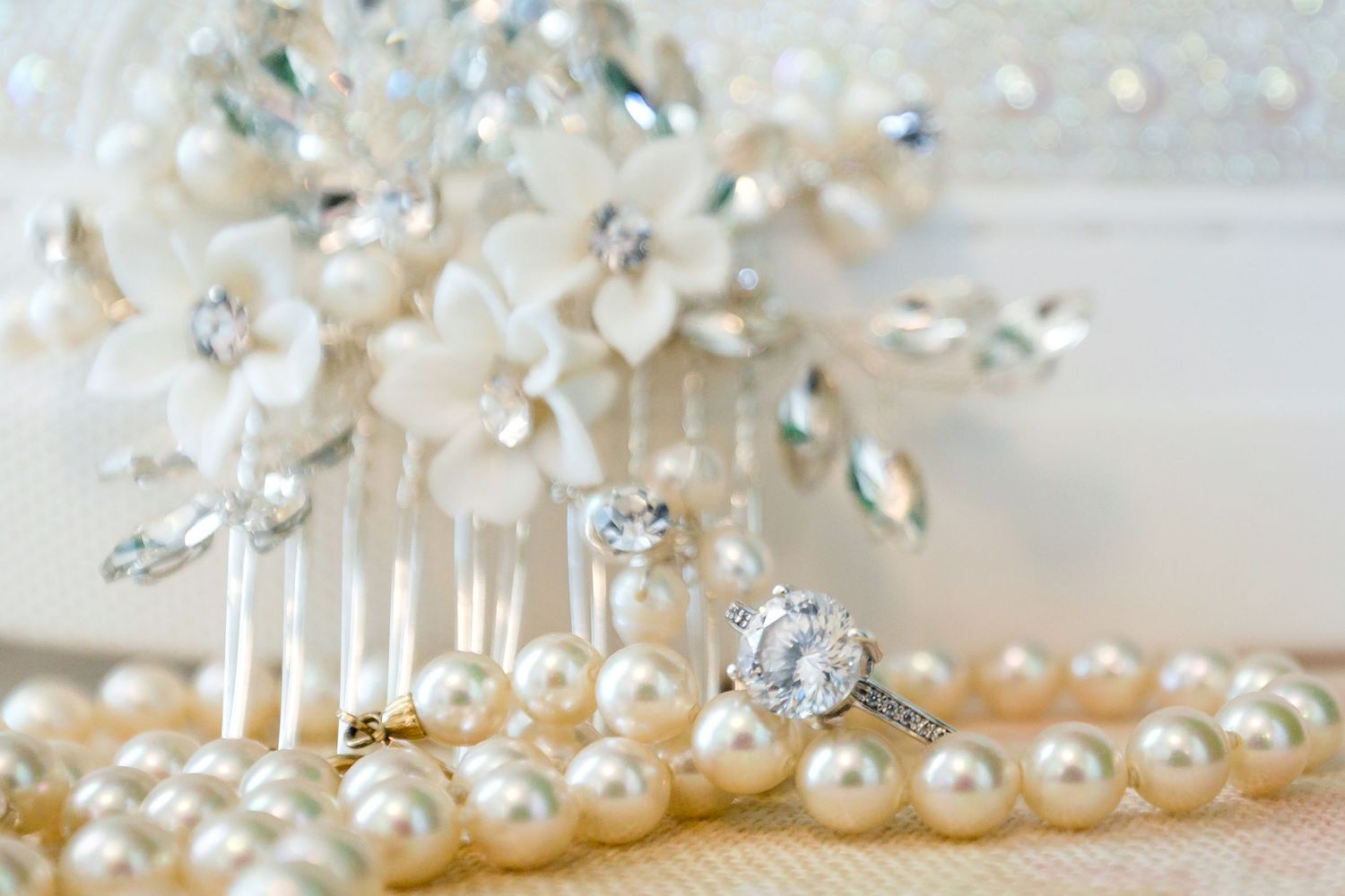Delicate pearl and crystal bridal accessories arranged in an elegant display.