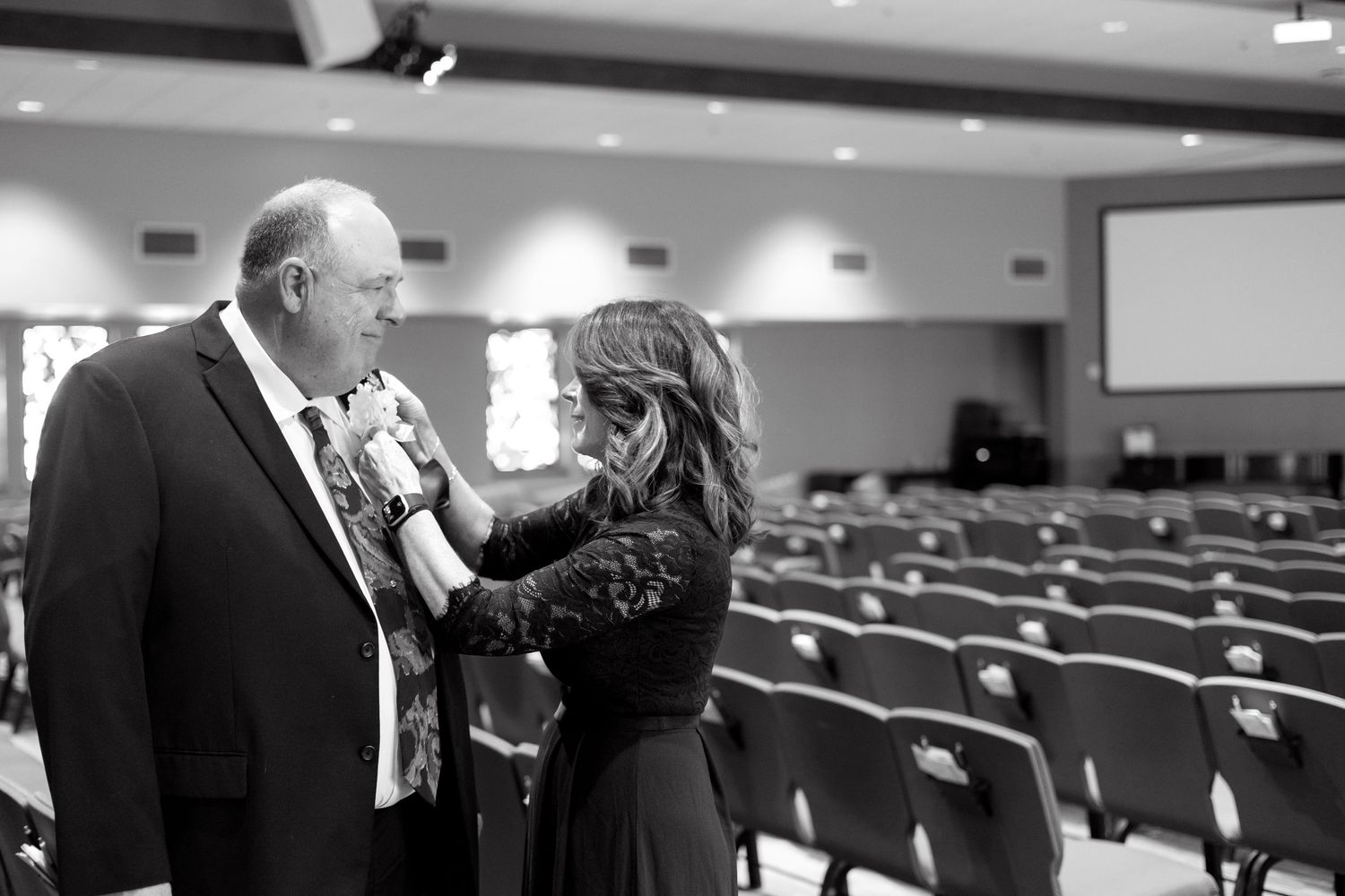 Black and white images of people in formal attire in an auditorium setting.