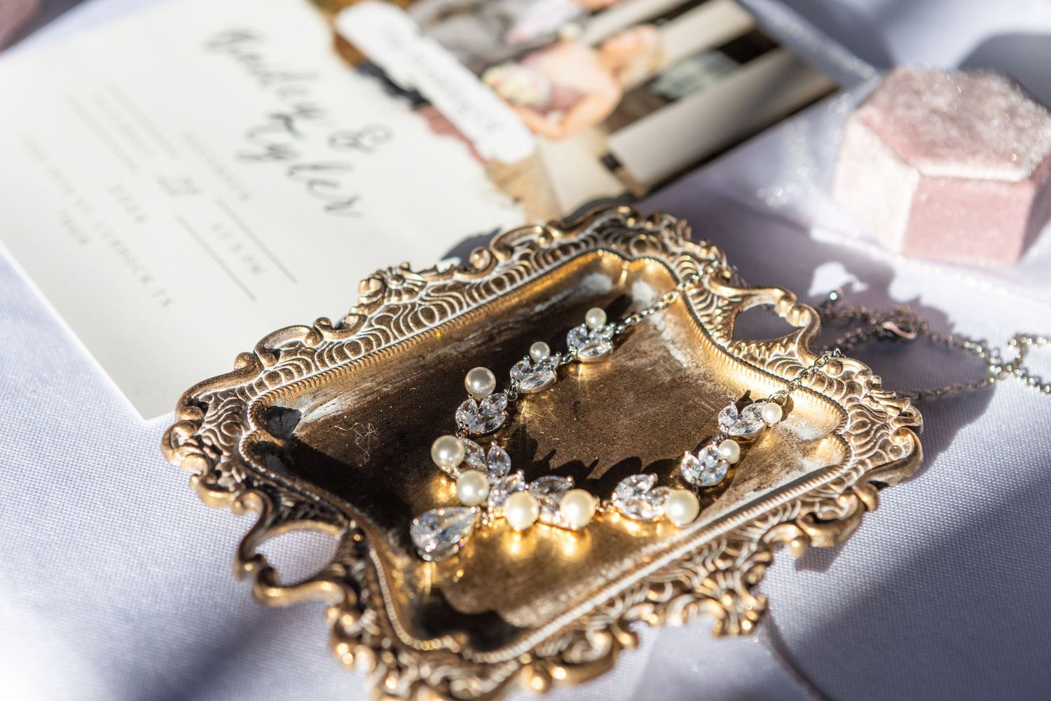 Ornate gold vintage frames with crystal details photographed in soft lighting.