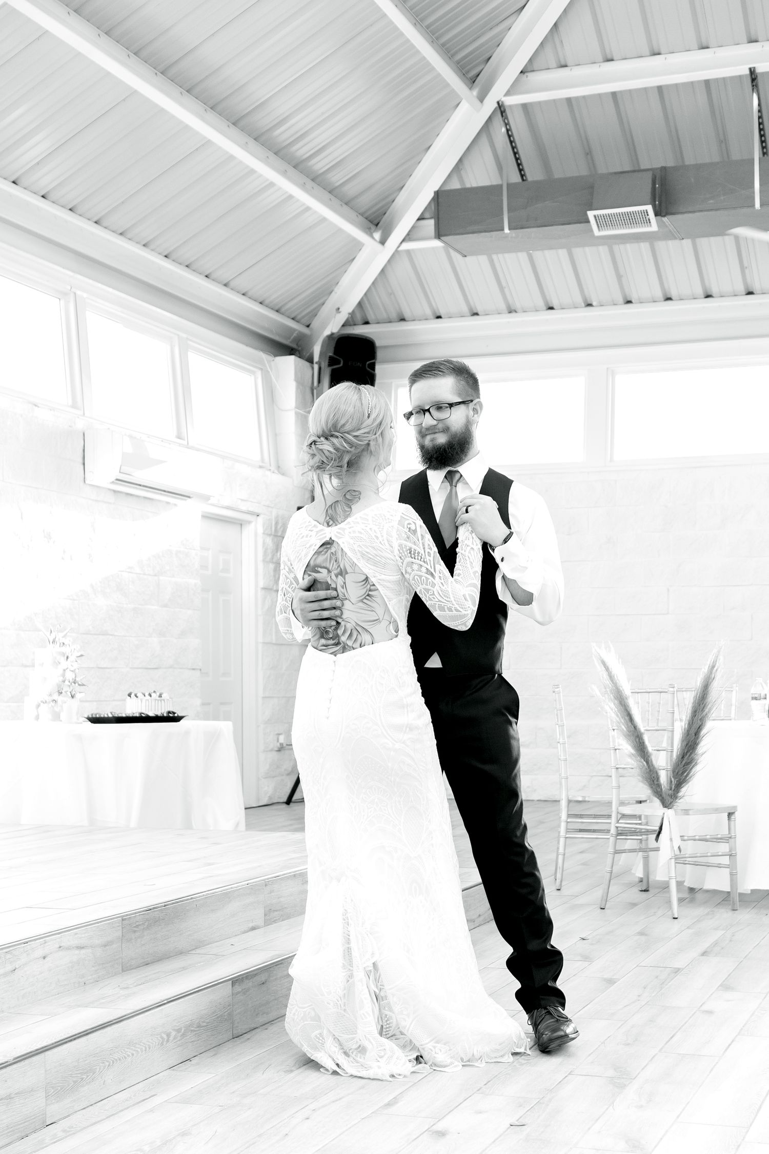 Black and white photos showing a couple dancing in an elegant indoor venue.