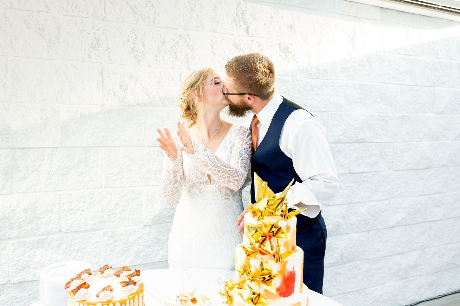 Wedding couple sharing intimate moment with yellow floral bouquet.