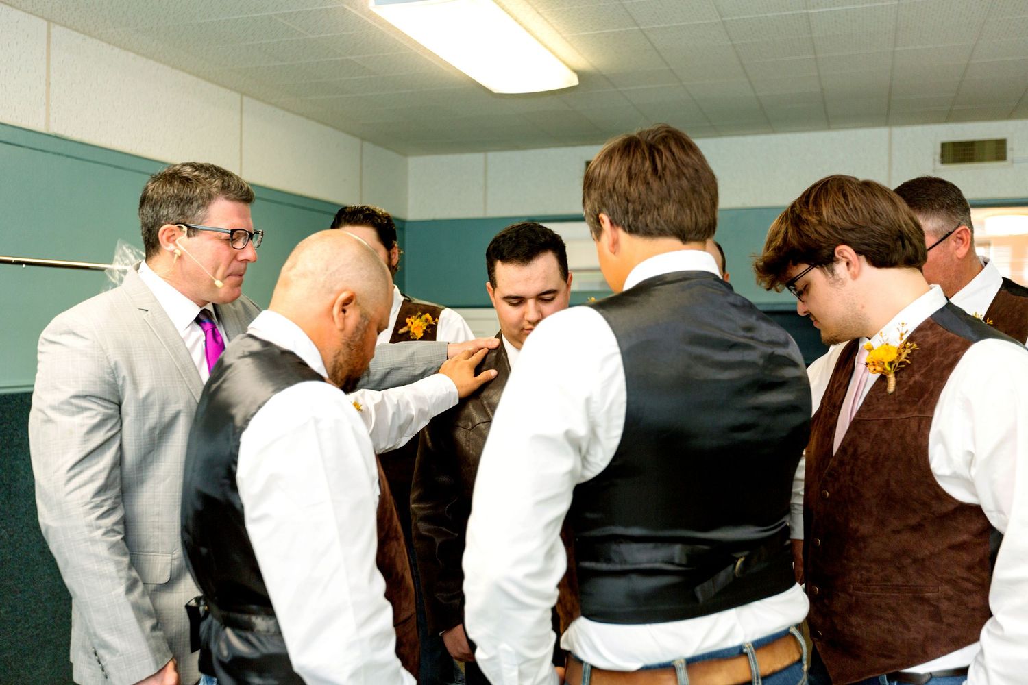 Groomsmen lined up in formal attire preparing for a wedding ceremony.