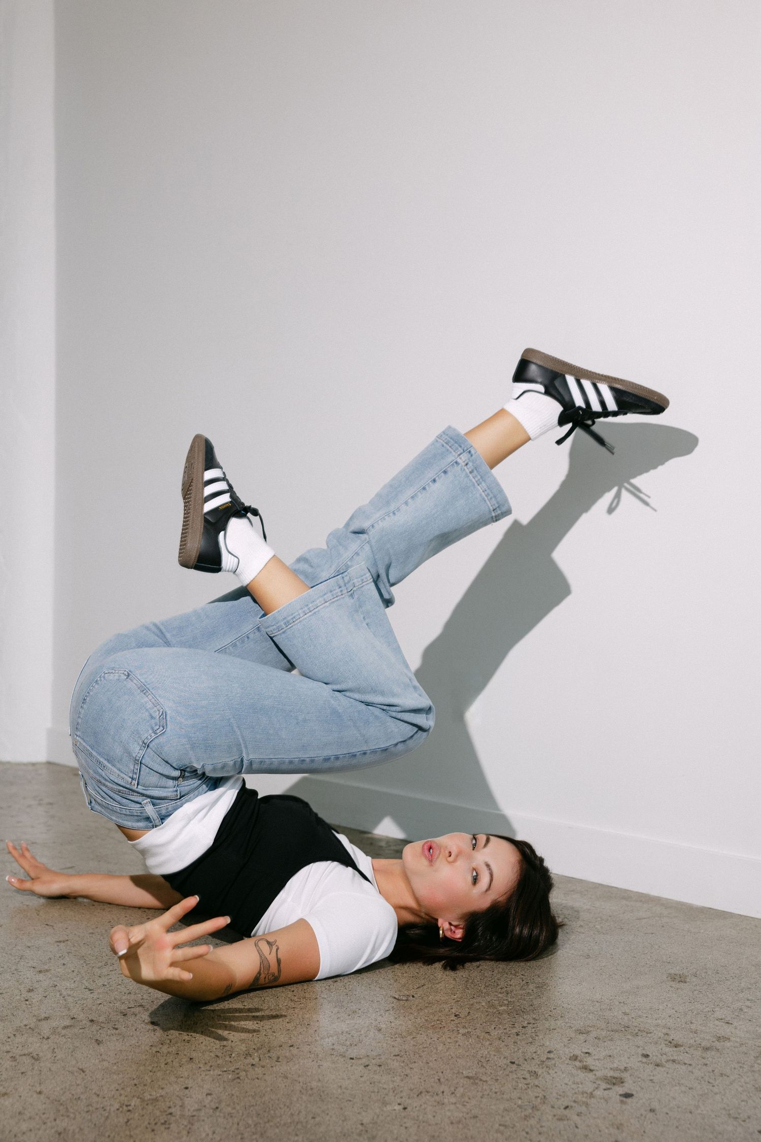 Series of dynamic floor poses showing movement in denim and black clothing.