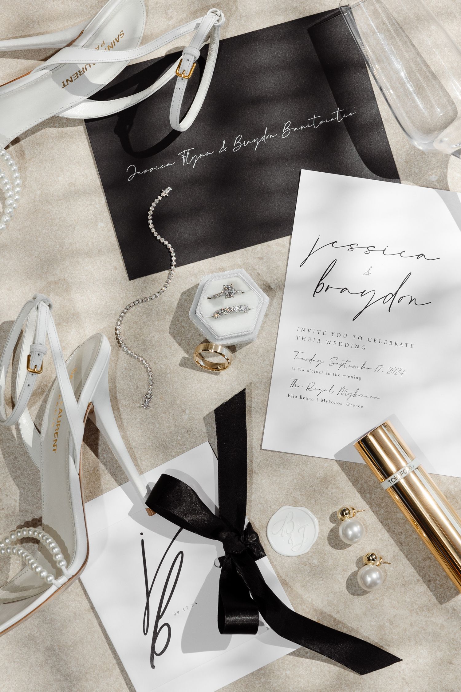 Elegant wedding accessories flatlay with invitation, white shoes, jewelry and perfume.