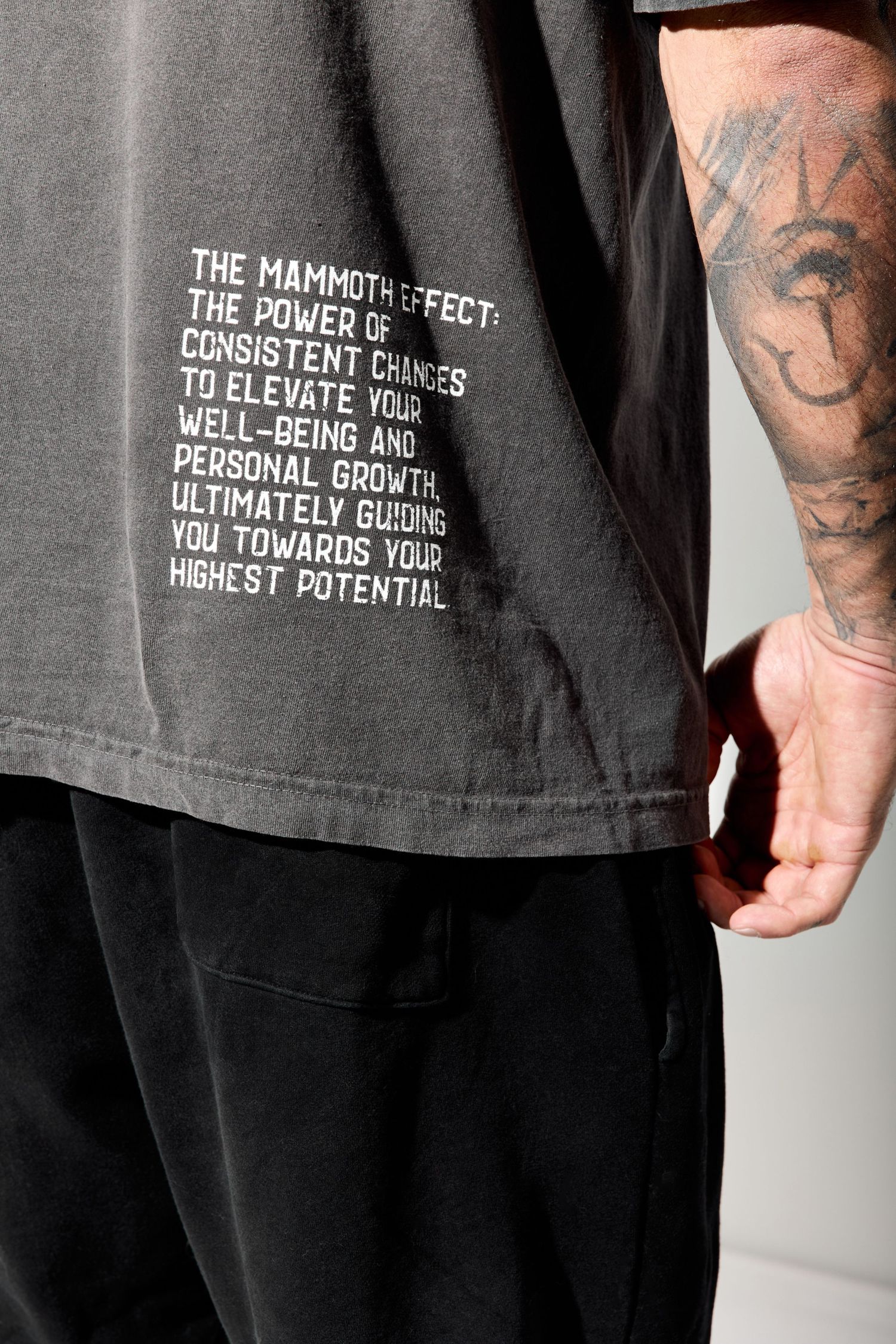 Close-up of inspirational text printed on dark gray t-shirt design.