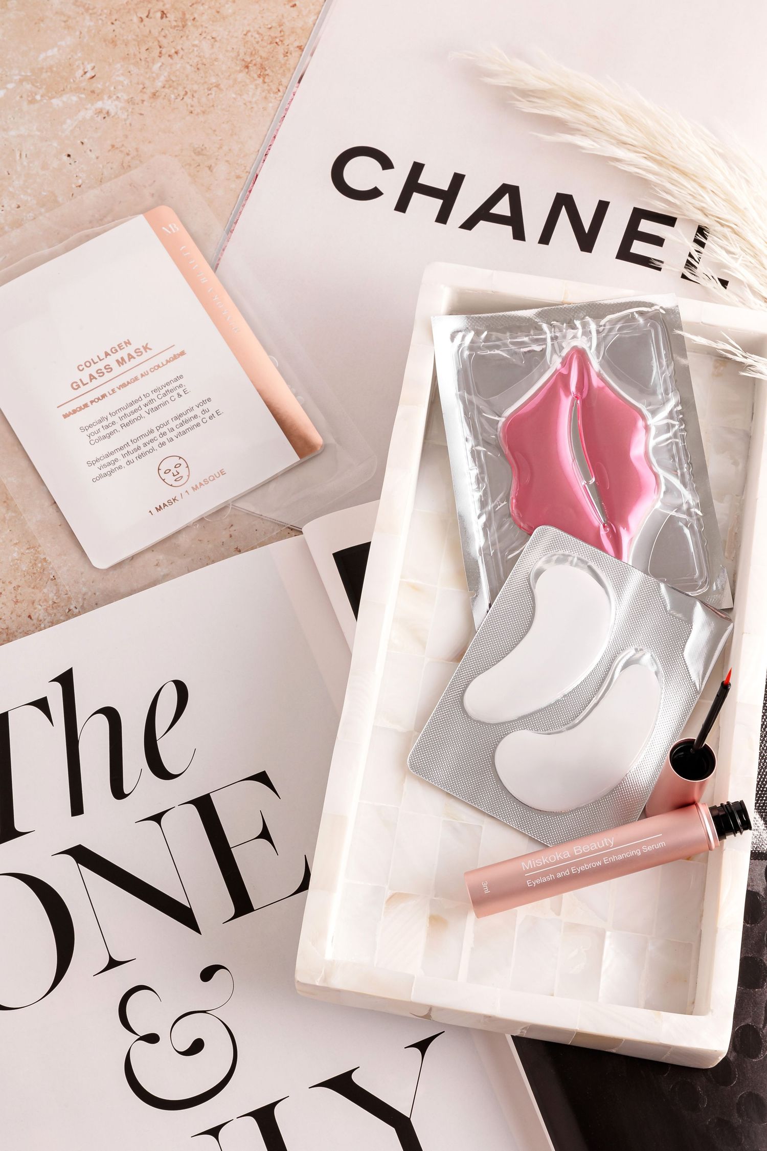 Luxury skincare products and eye patches styled with fashion magazine text.