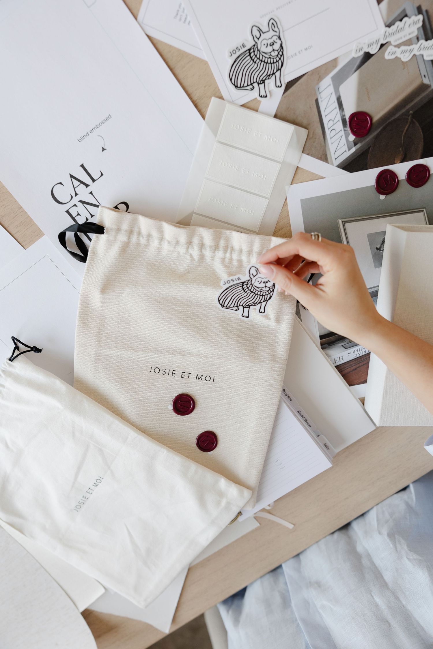 Overhead view of fabric pouches with cute animal illustrations and red wax seals.