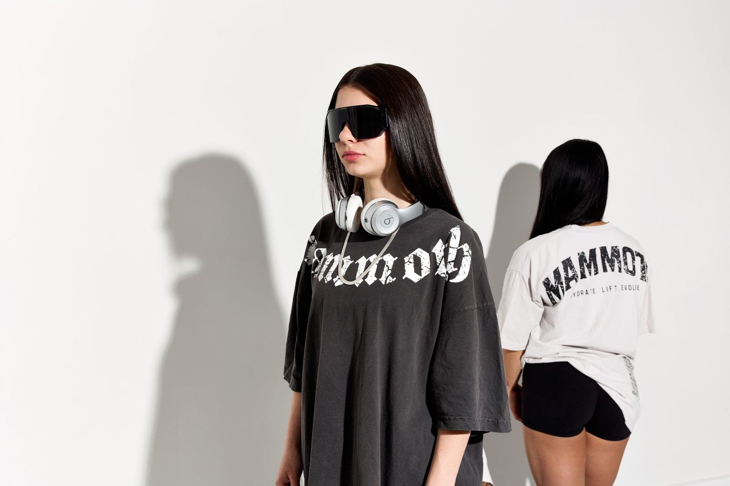 Models showcase black and white Mammoth branded streetwear collection against white background.