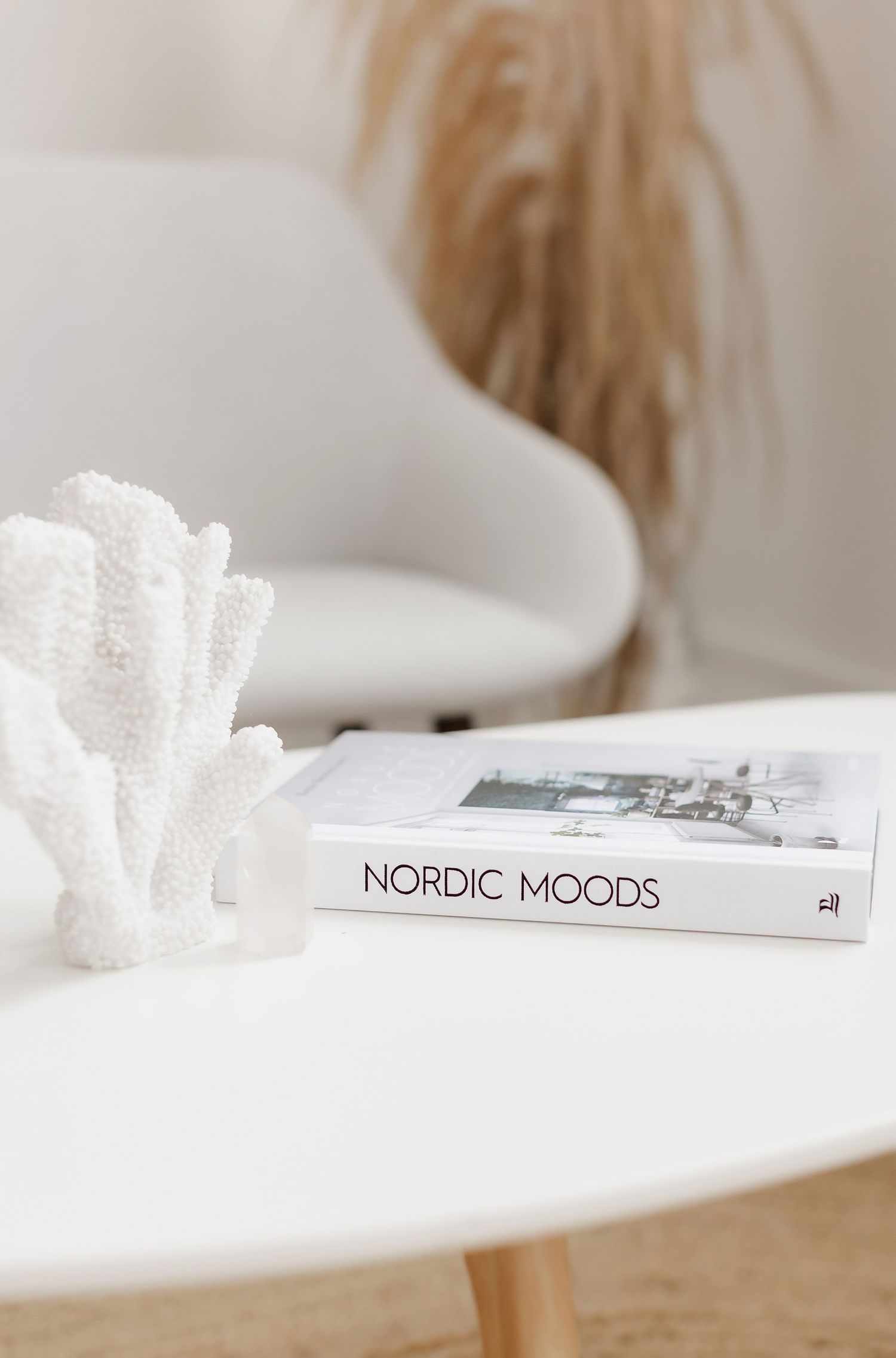 Nordic Moods book displayed on white surface with soft styling elements.