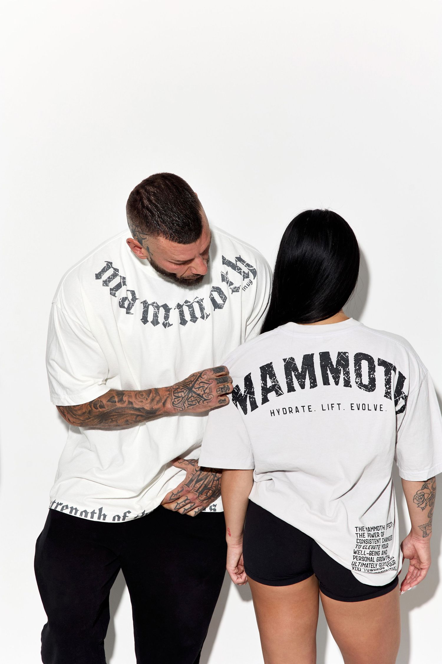 Models in white Mammoth t-shirts pose playfully against white studio background.