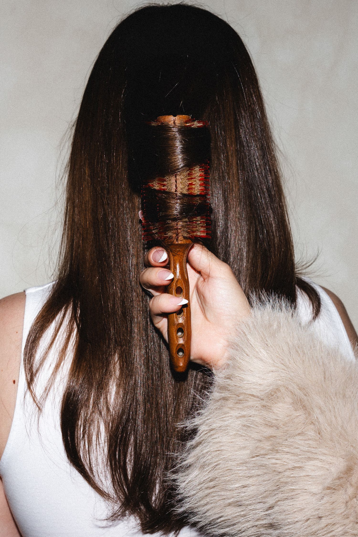 Hair styling process with furry white accent and brown hair.