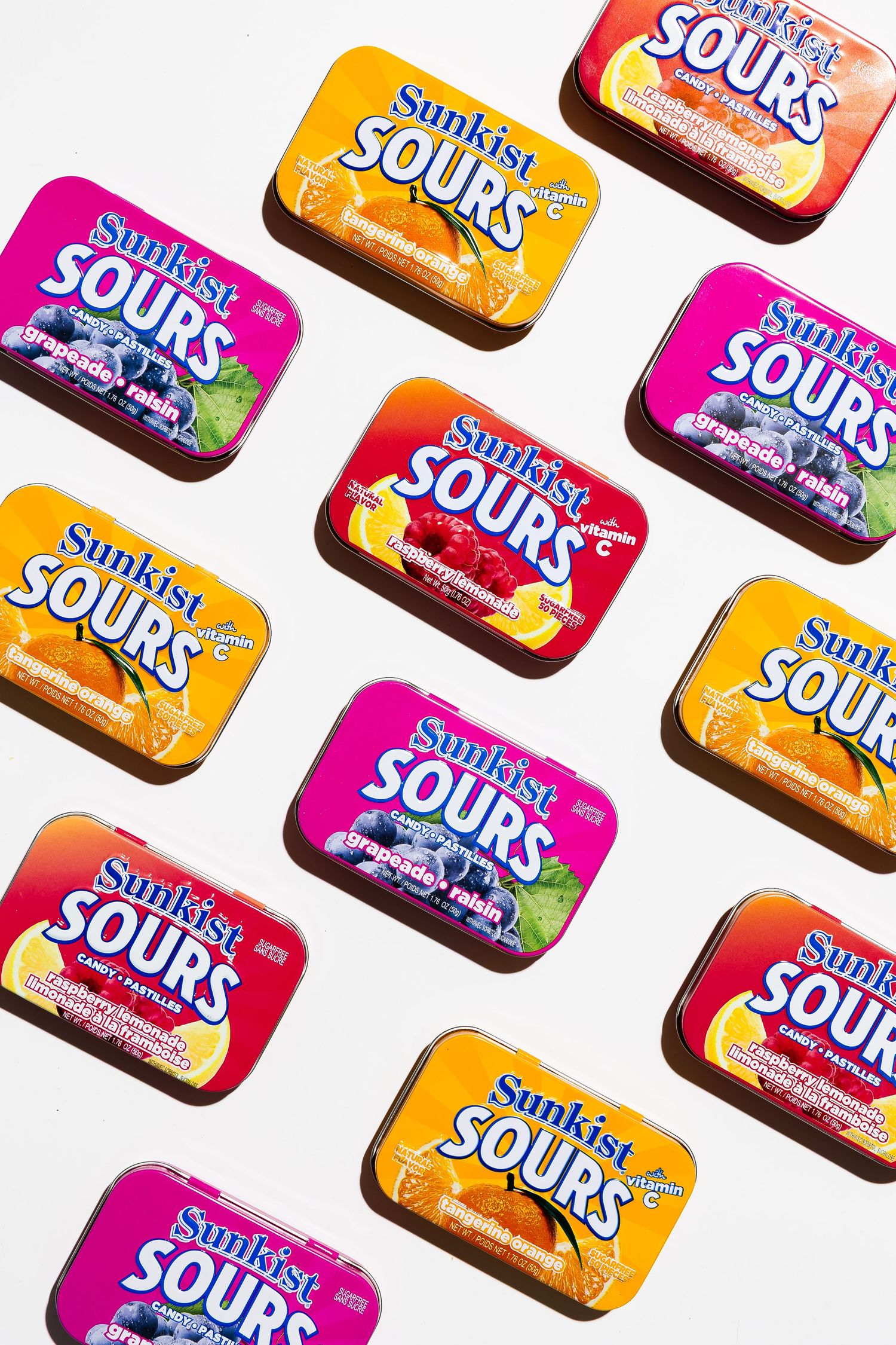 Sunkist Sours candy packages arranged in diagonal pattern on white background.
