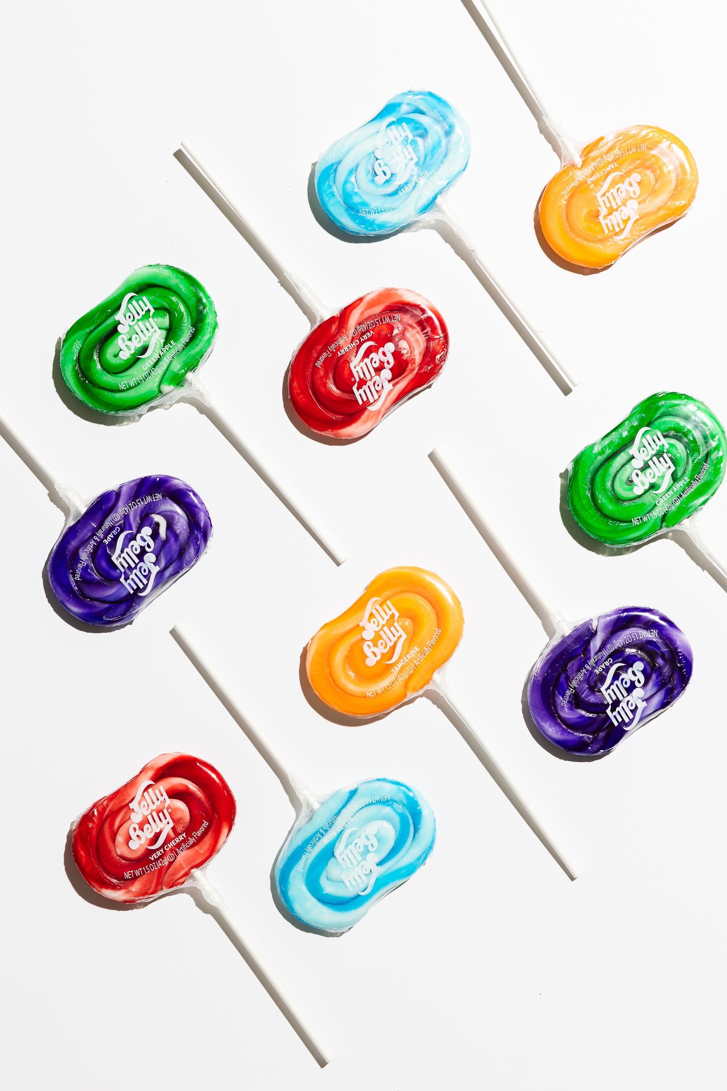 Colorful lollipops arranged in diagonal lines against white background.