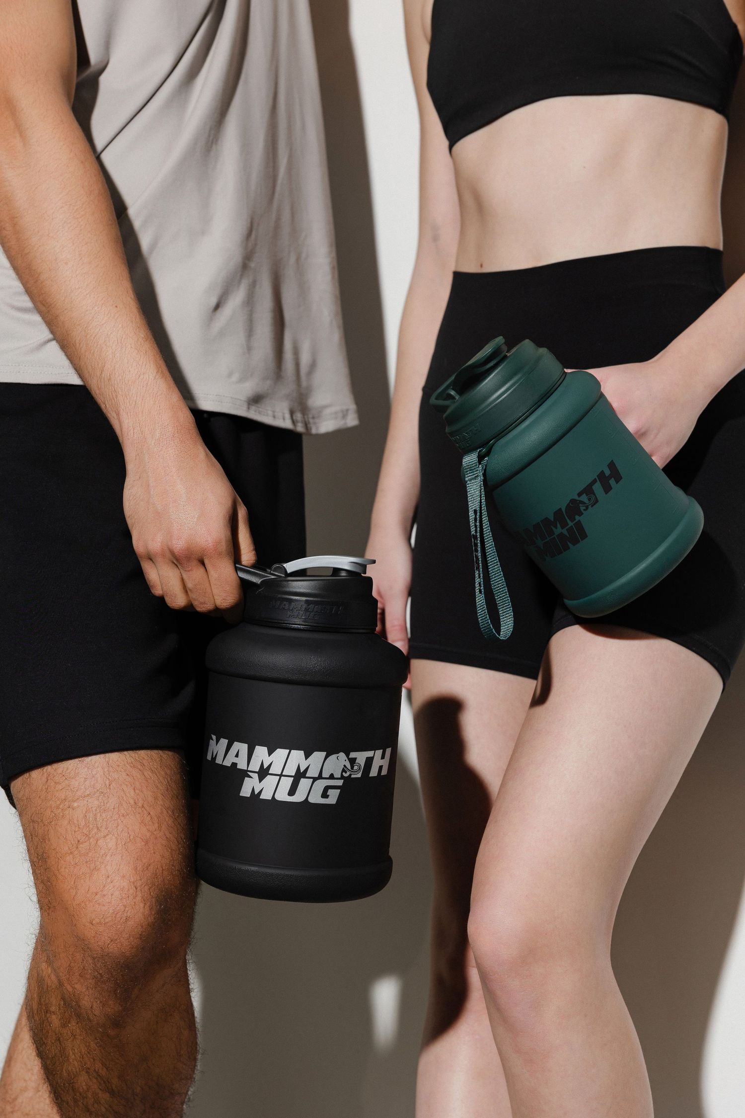 Close-up of athletic wear and fitness containers in black and green colors.