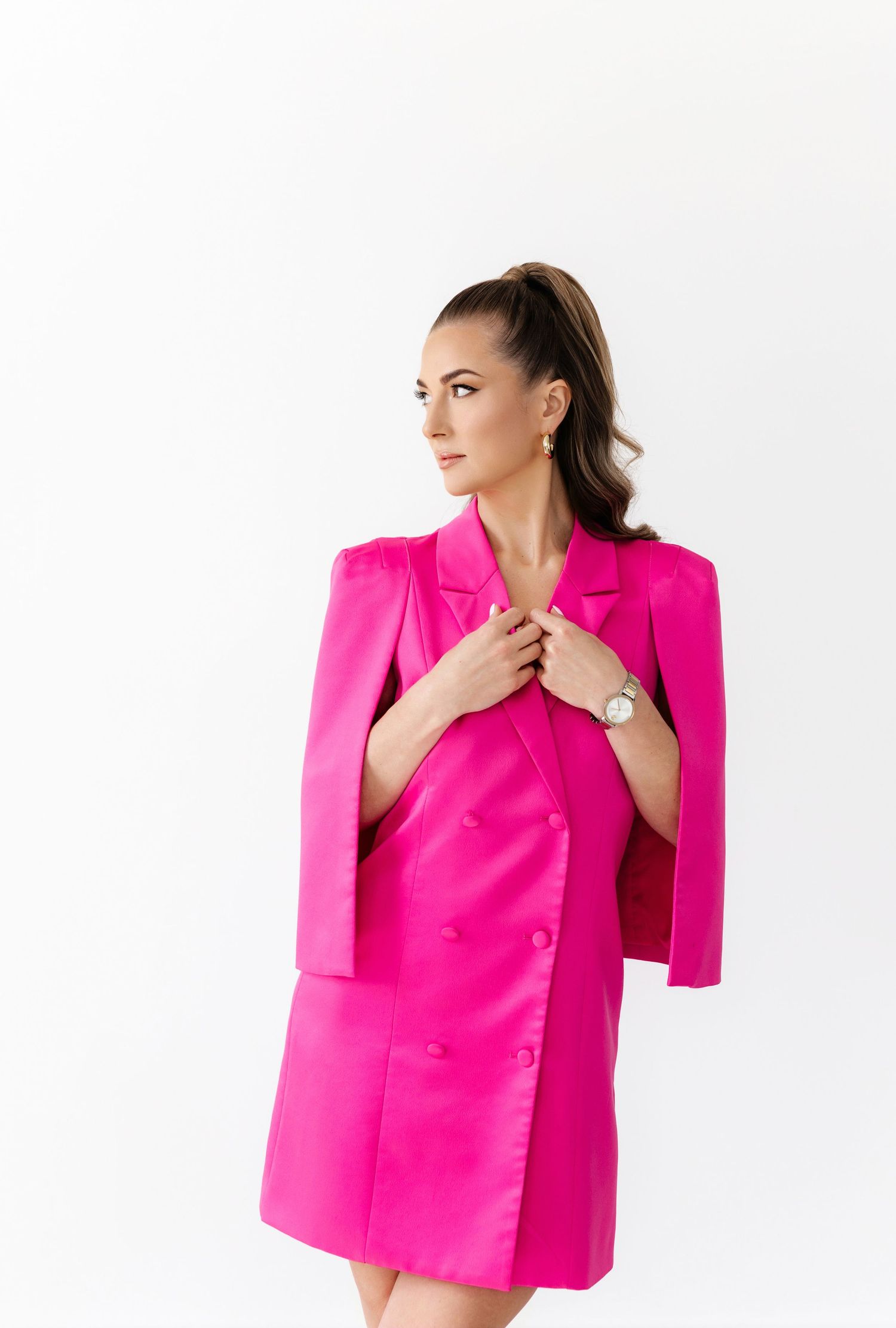 Bright fuchsia structured blazer displayed in editorial style poses against clean white studio setting.