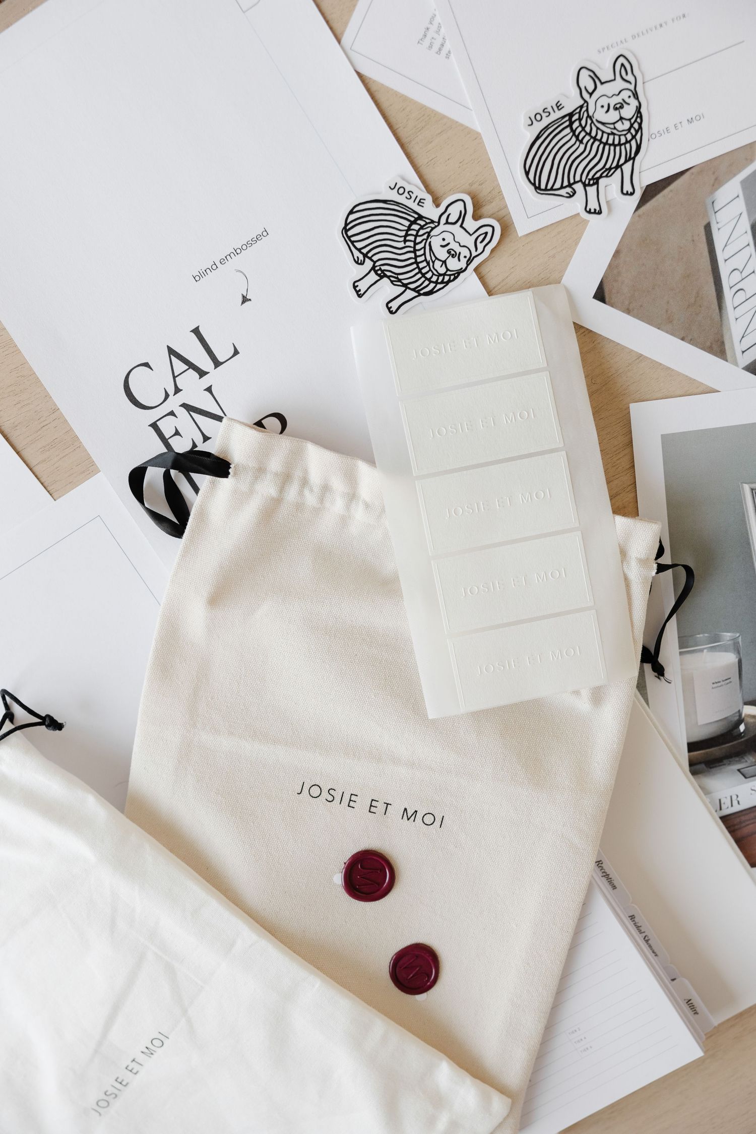 Minimalist white envelopes with red wax seals and cat illustrations on cards.