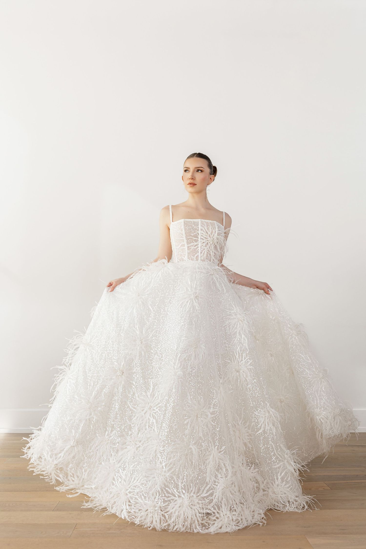 Dramatic full-skirted white lace wedding gown shown in multiple angles on wooden floor.