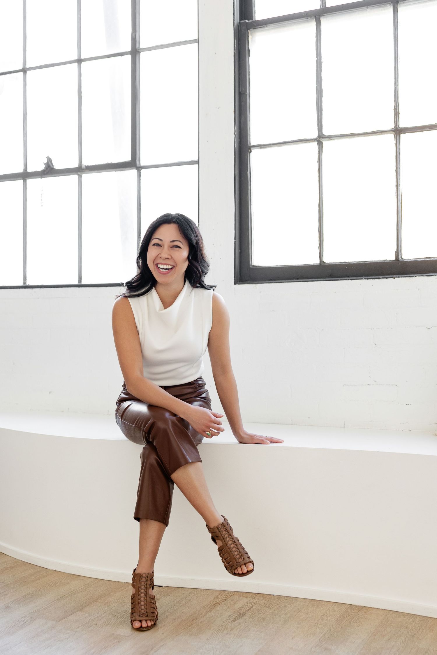 Bright studio setting with white walls and large windows for lifestyle photography.