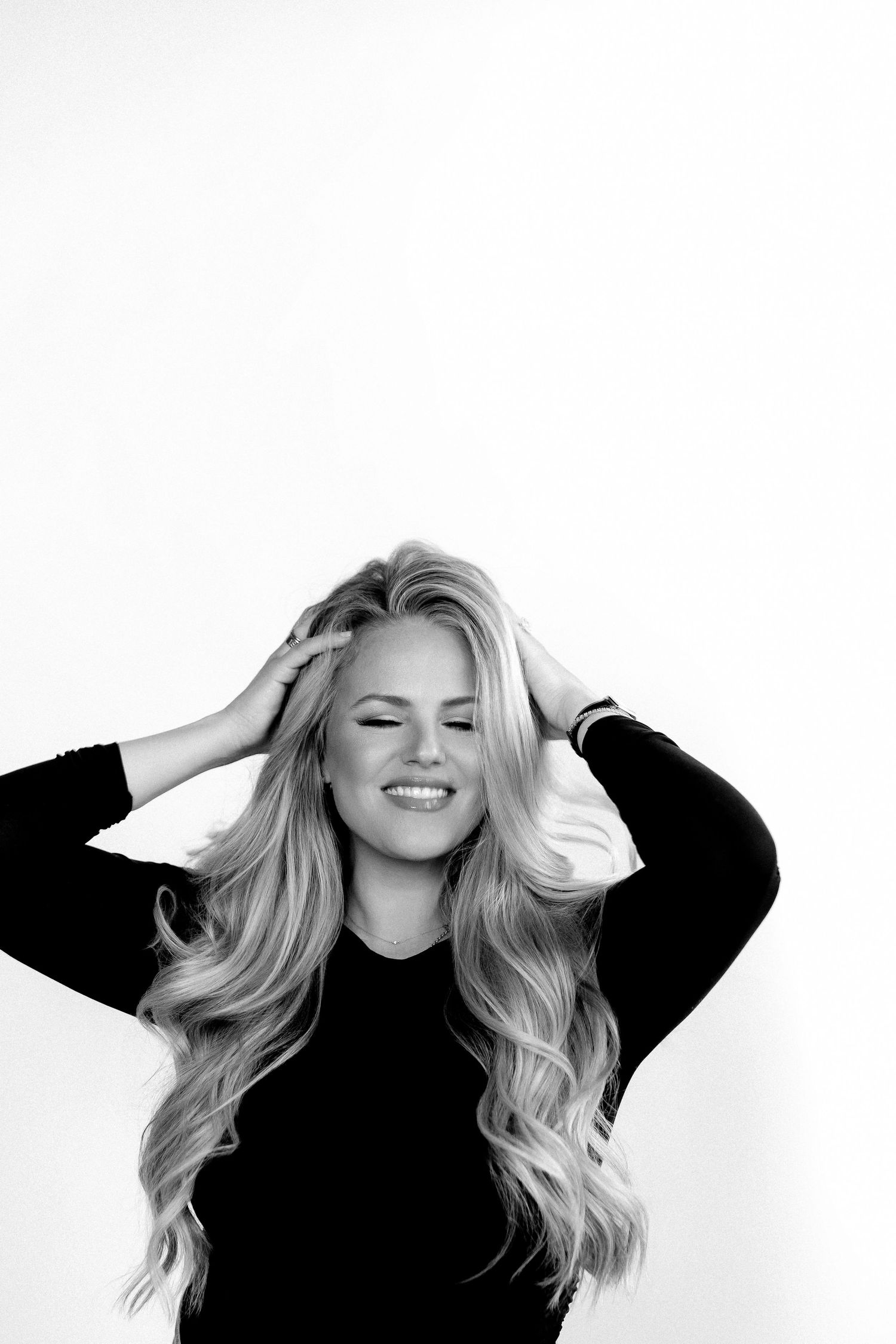 Black and white portraits with flowing hair and black top showing natural movement.
