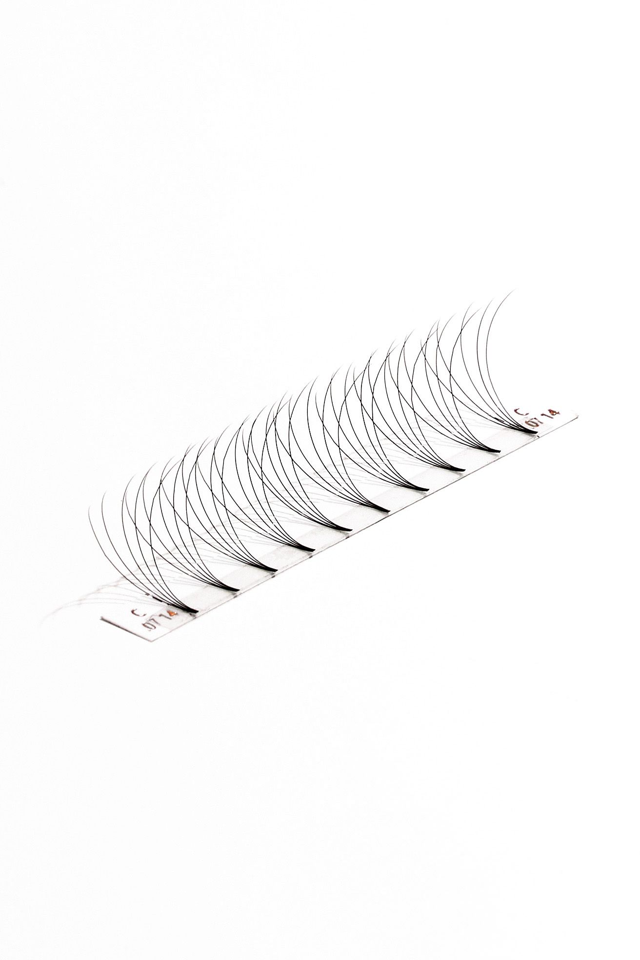 Single strip of false eyelashes showing curved individual lash fibers on white background.