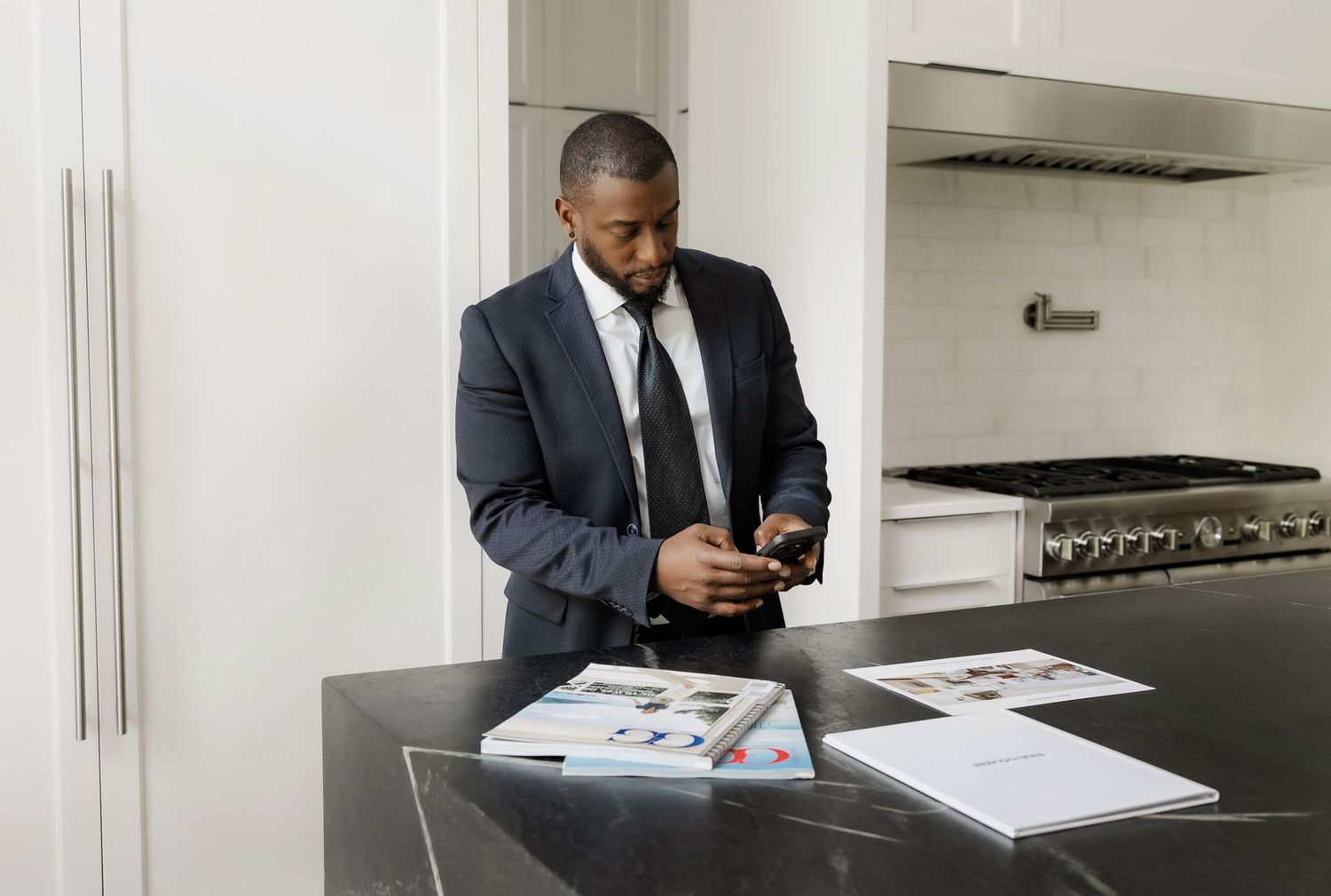 Business professional working with documents at a modern office desk.