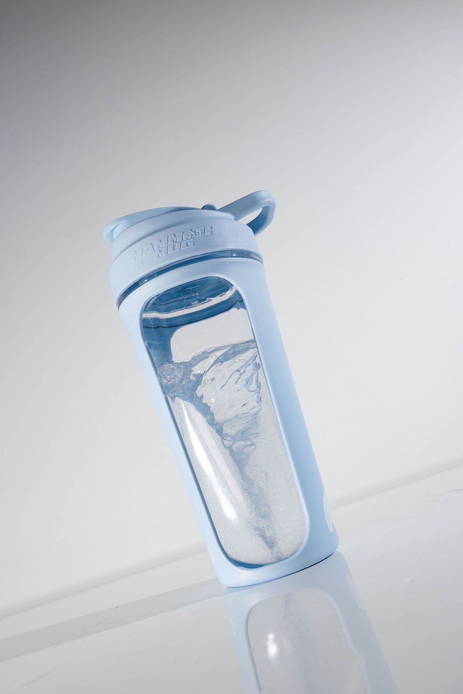 Clear water bottle with blue lid showing water movement inside.