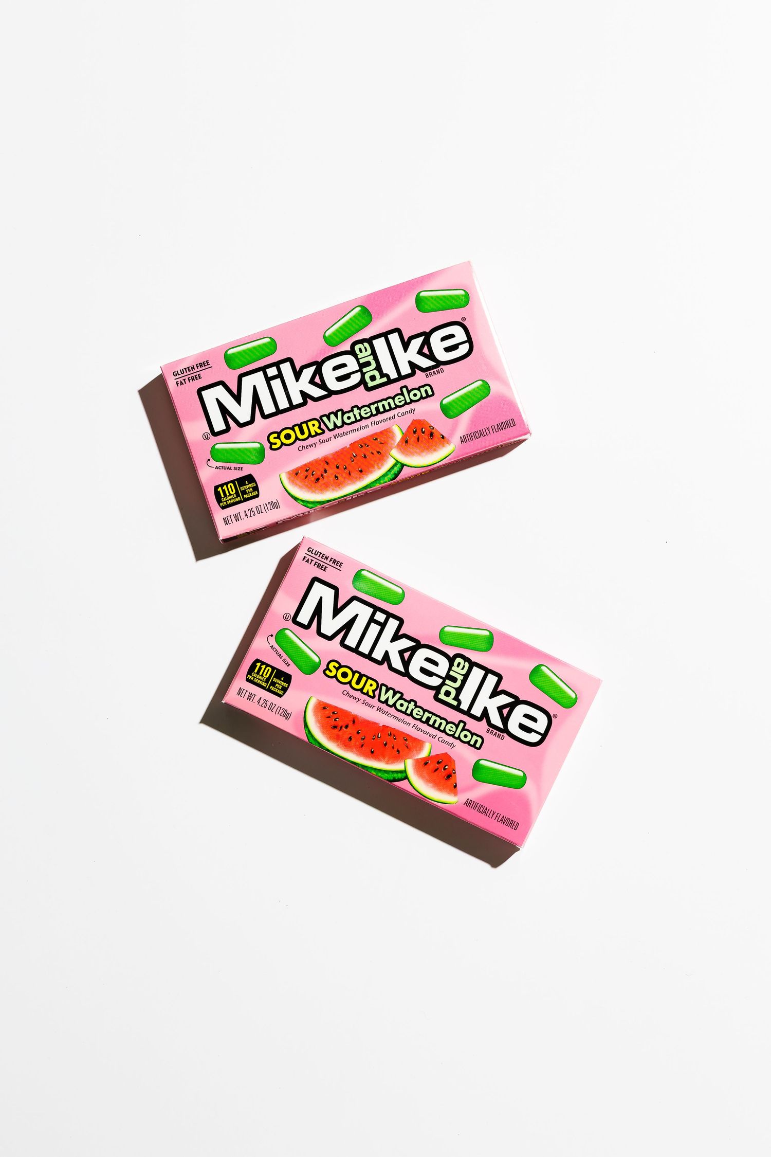 Pink watermelon flavored Mike and Ike candy boxes on white background.