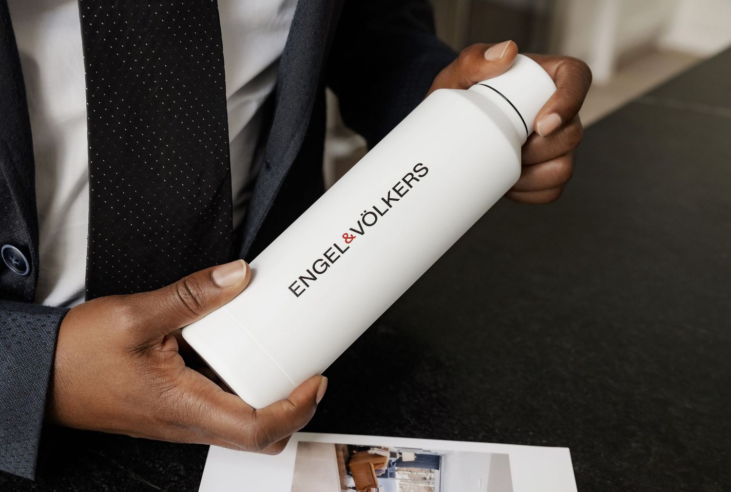 Professional examining marketing materials and brochures in an office environment.