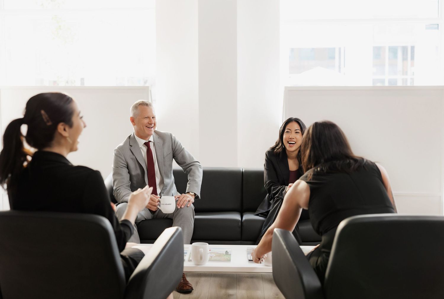 Business meeting in progress inside modern office conference room.
