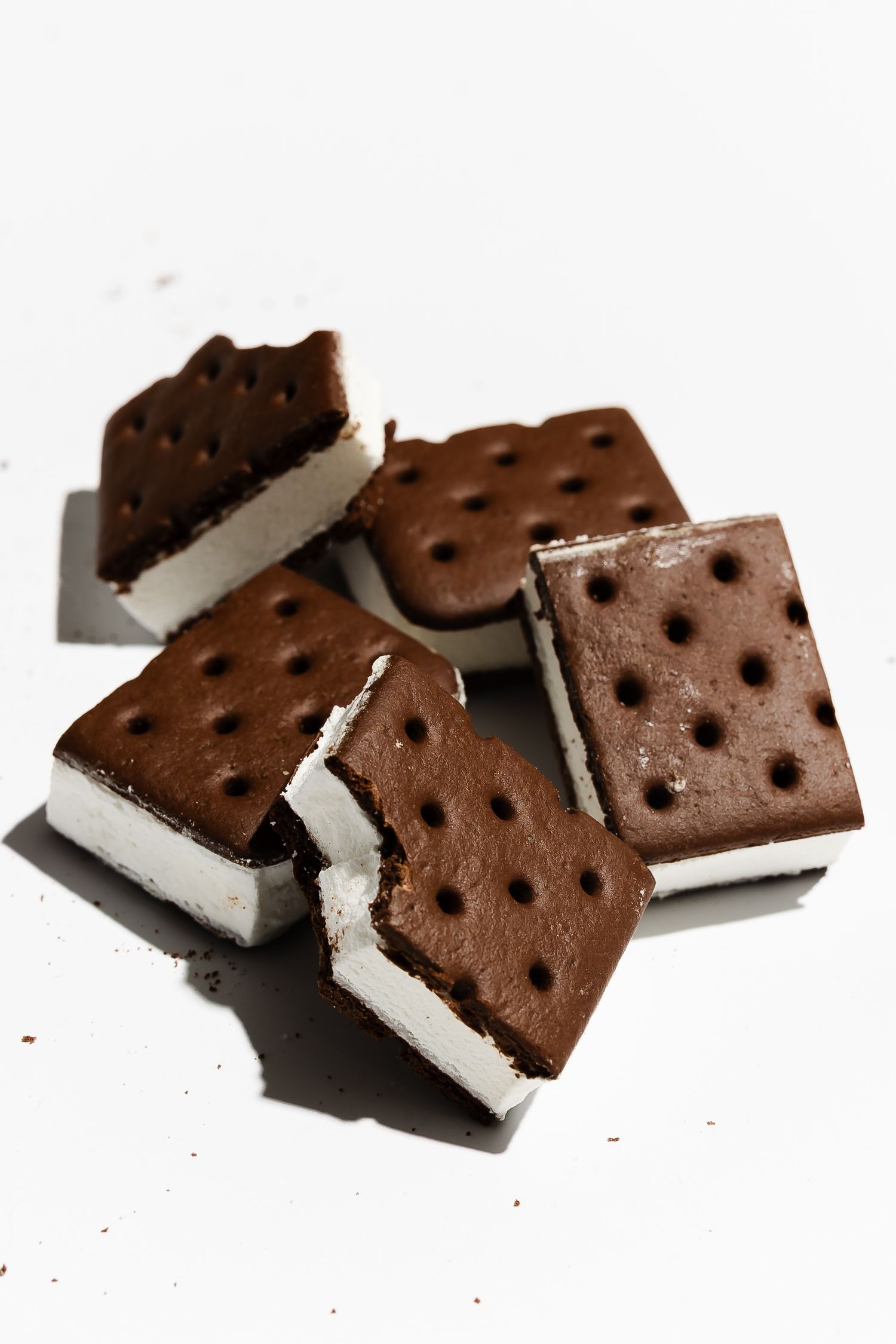 Ice cream sandwich cookies with chocolate wafers and vanilla filling broken into pieces.