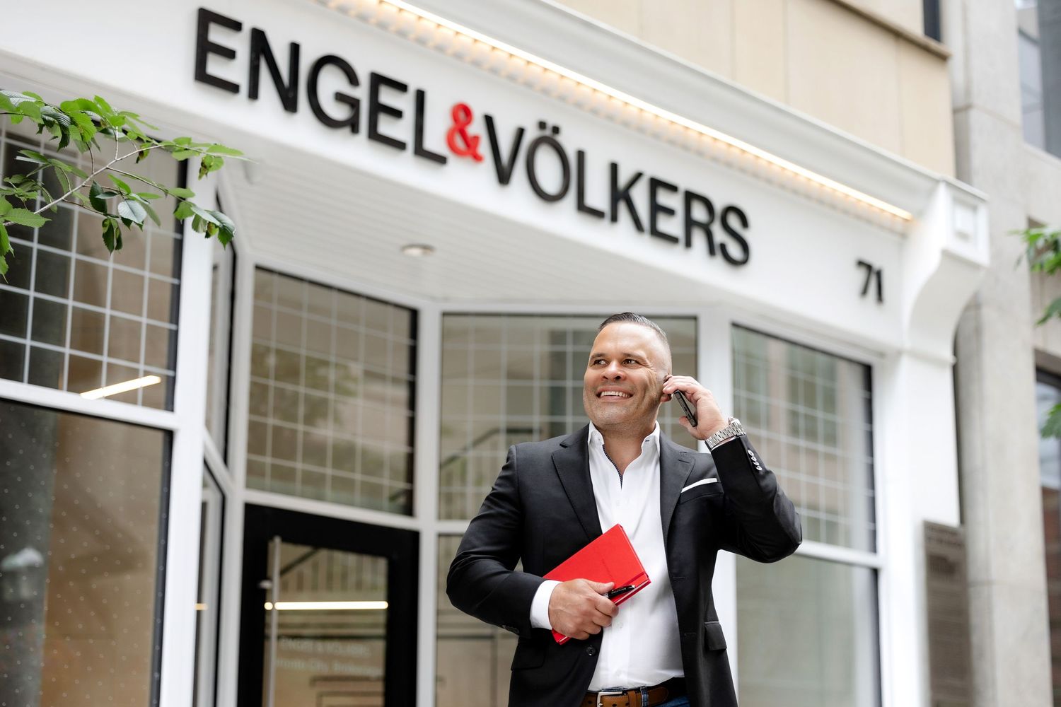 Exterior view of Engel & Volkers real estate office storefront.