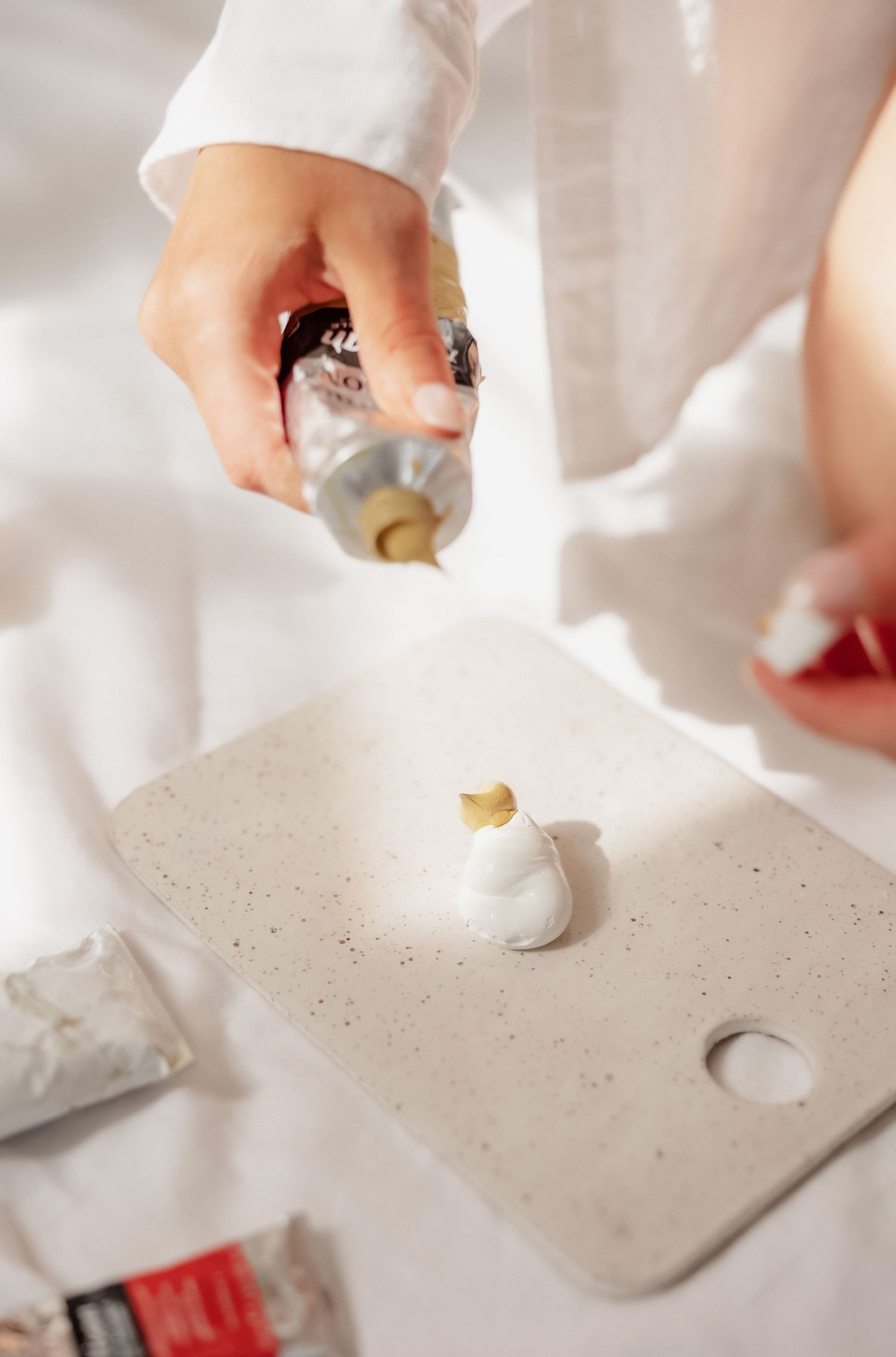 Close-up series of hands working with white clay or ceramic material.
