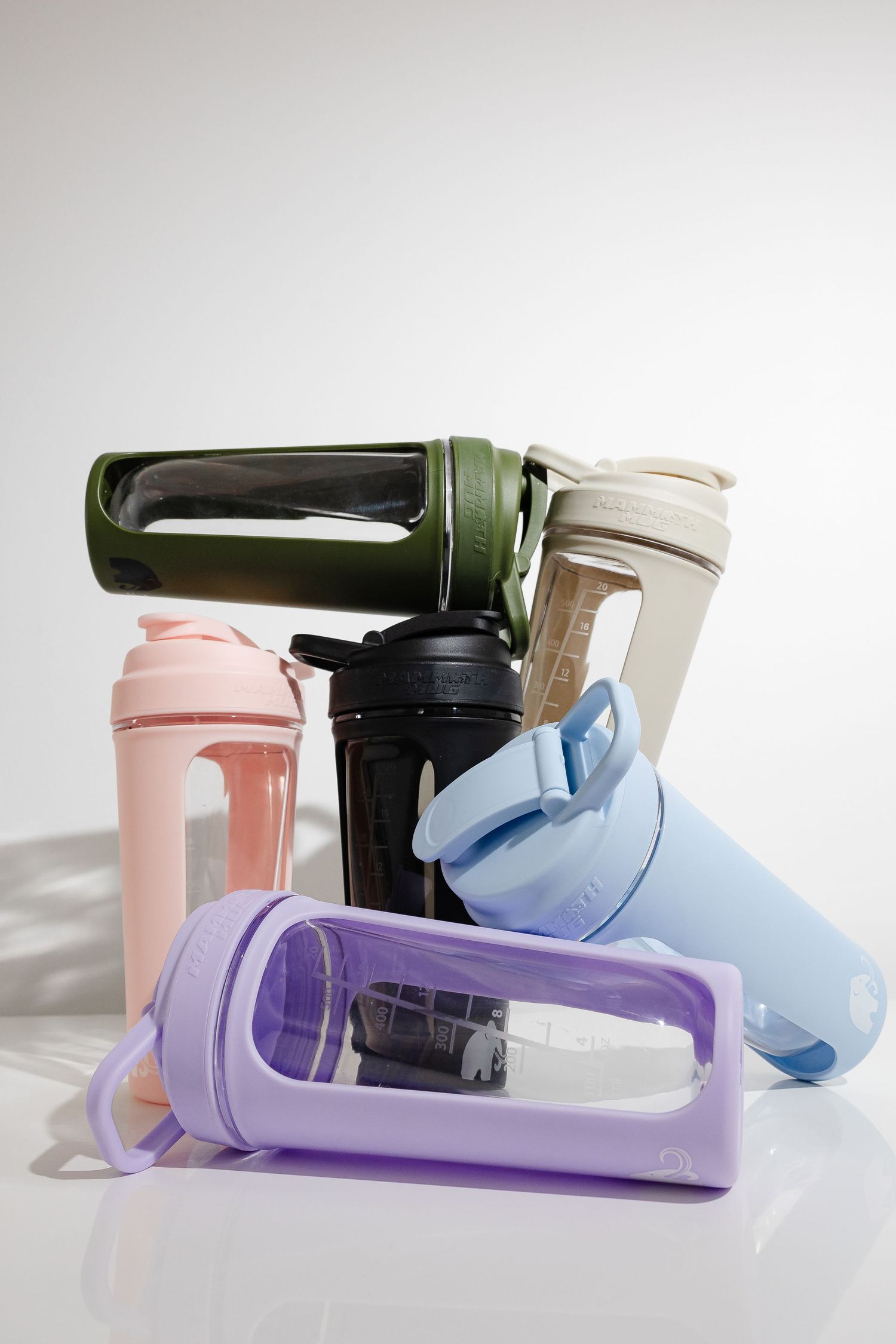 Colorful water bottles in pastel shades arranged in a diagonal line.