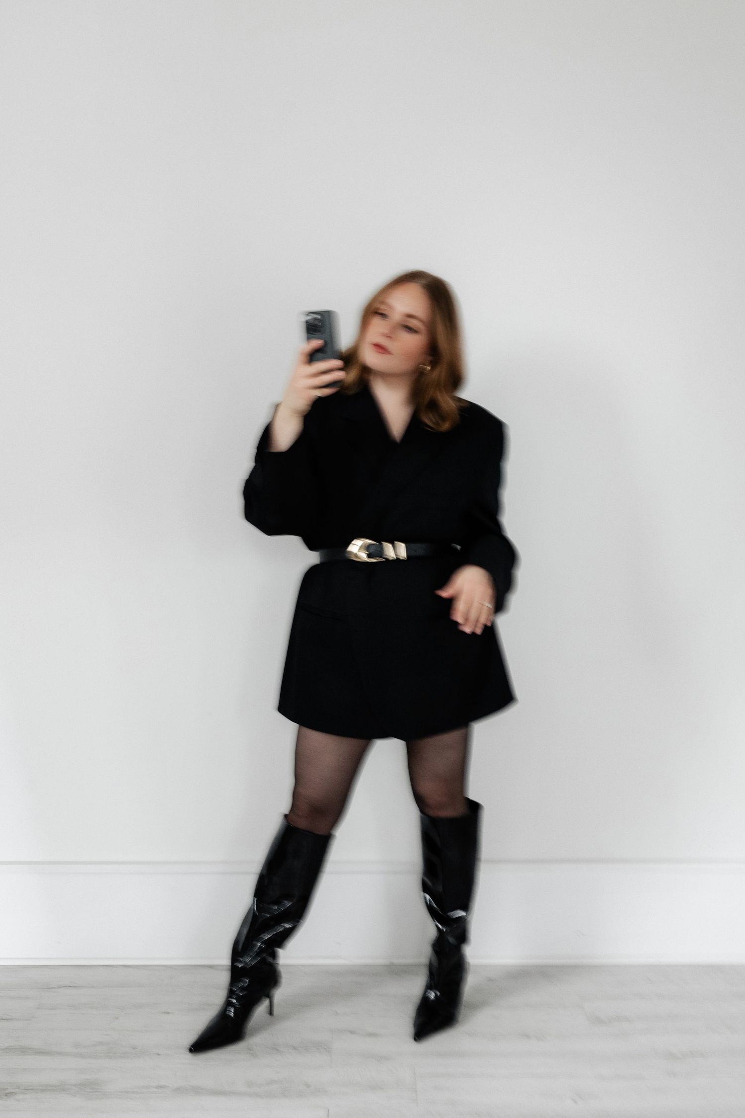 Artistic portrait series showing dynamic poses with phone and black outfit.