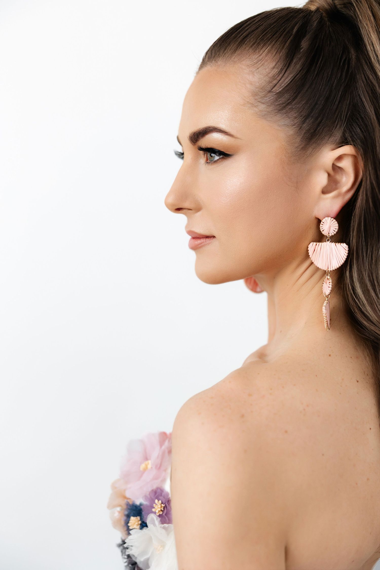 Close-up shots highlighting pink statement earrings and floral corset details.
