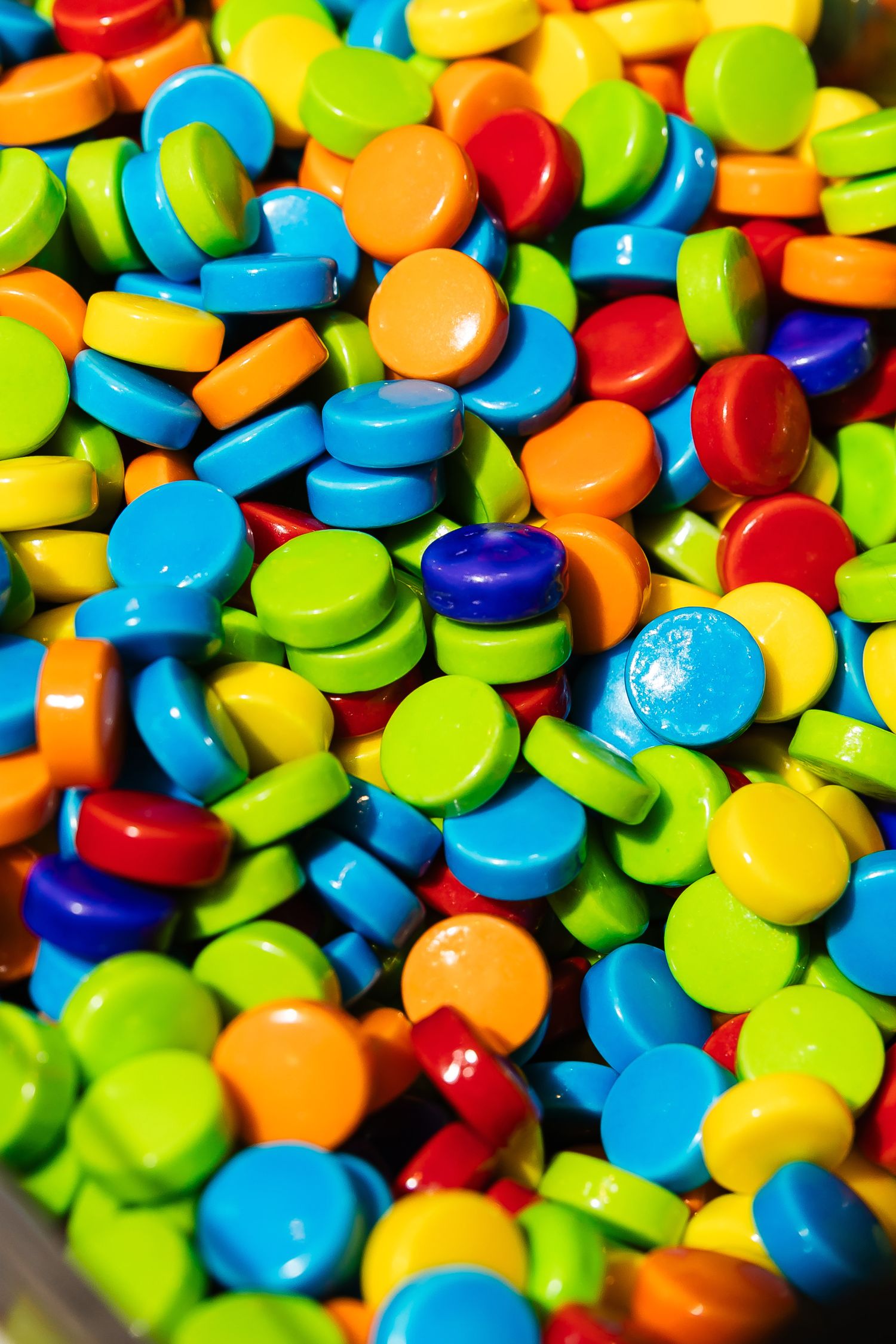 Vibrant collection of colorful candy buttons arranged in a close-up pattern.