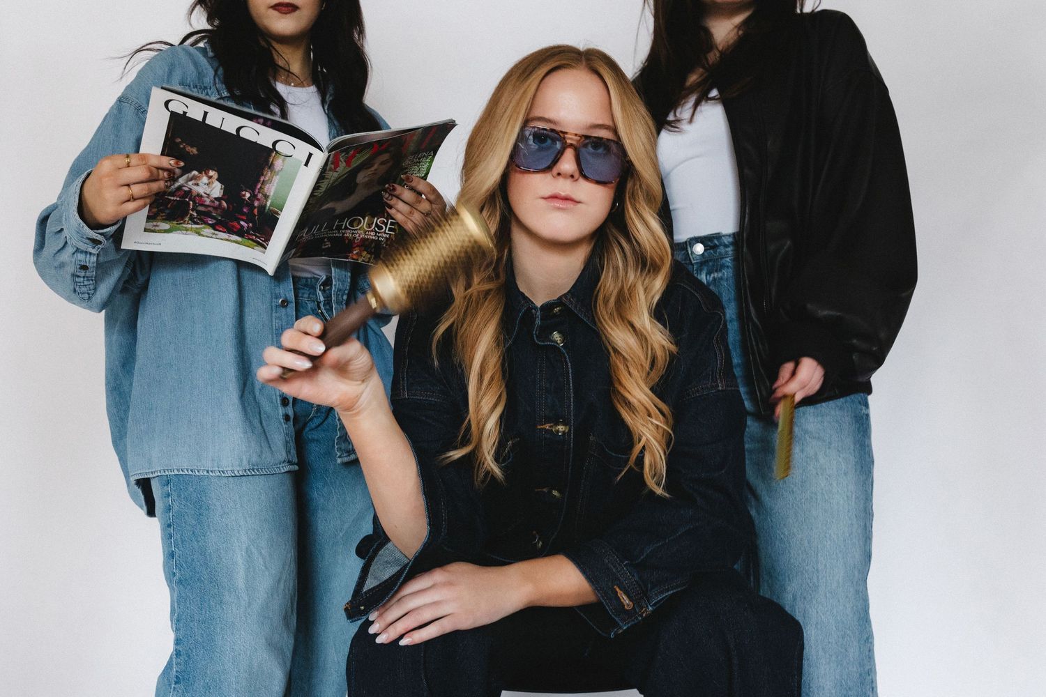 Fashion photography session with models in casual denim and black outfits.