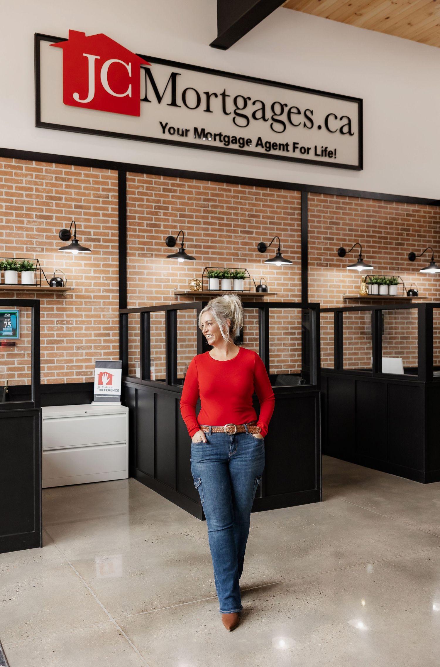 Professional office interior with JC Mortgages sign and industrial-style lighting fixtures.