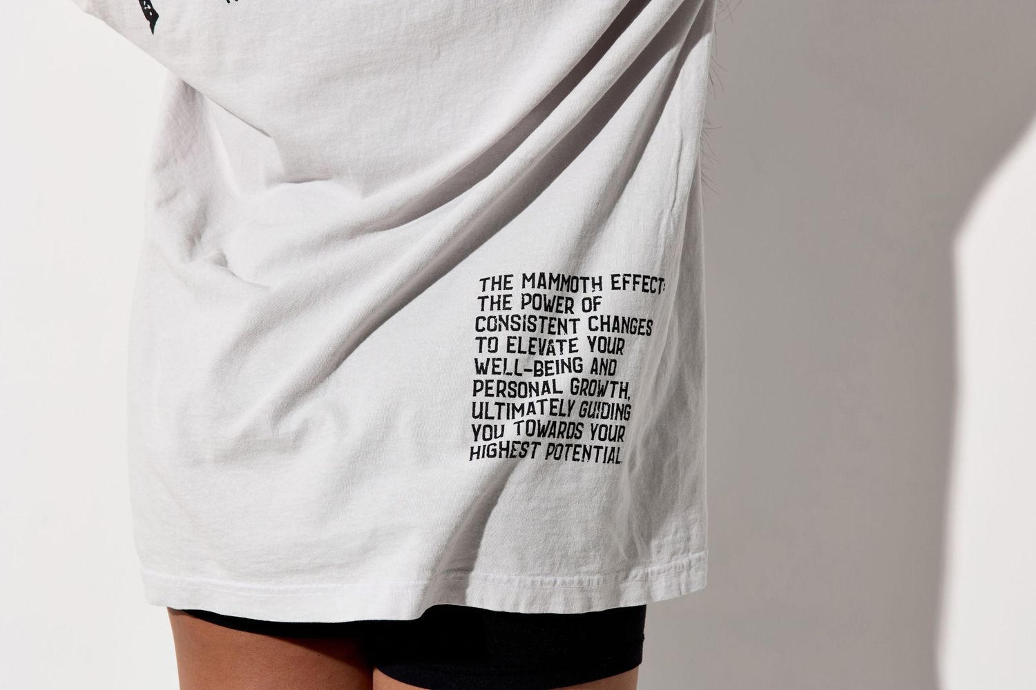 Close-up details of white Mammoth t-shirt design and branding text.
